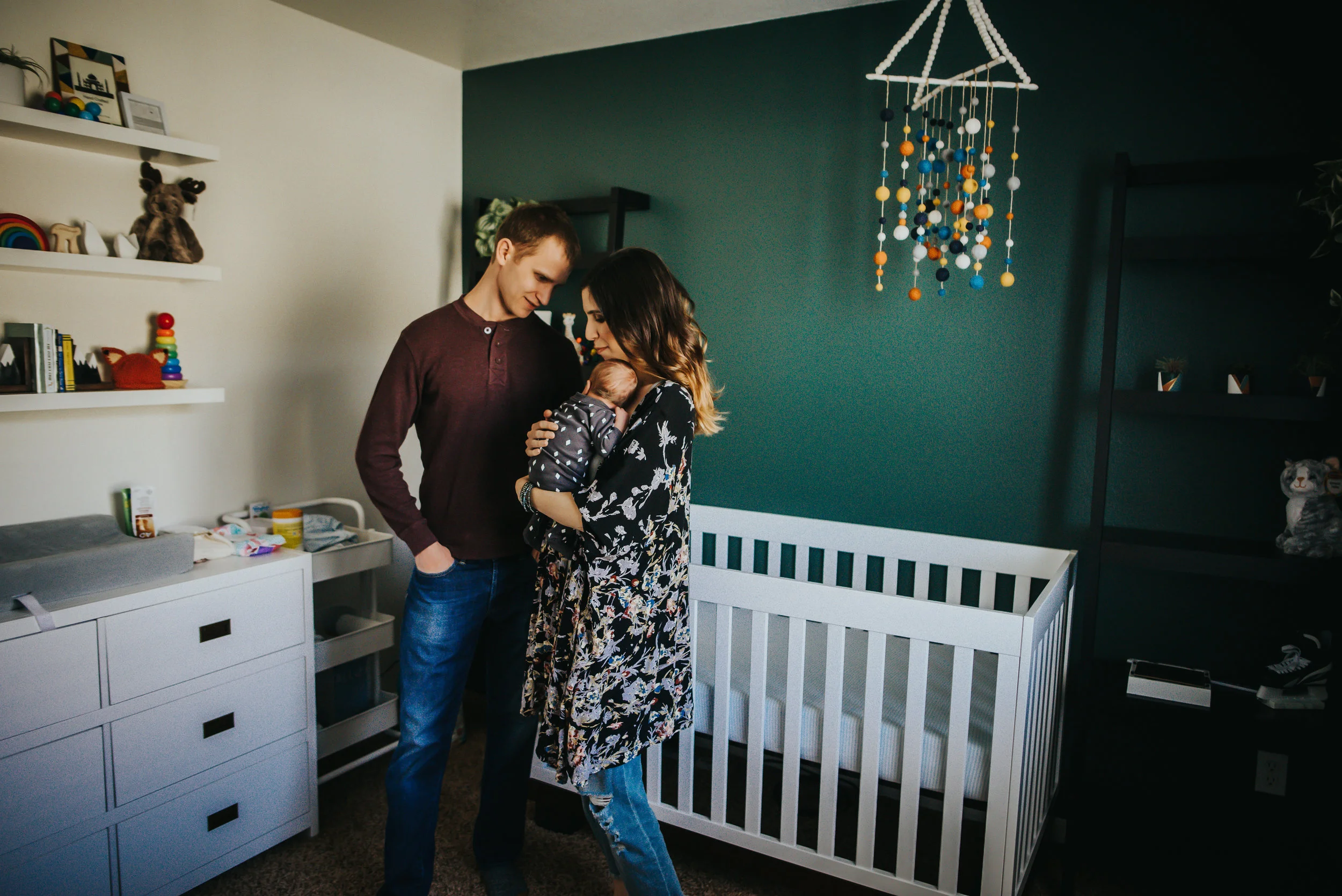 Mom and dad love on their newborn son in his nursery in Colorado Springs.