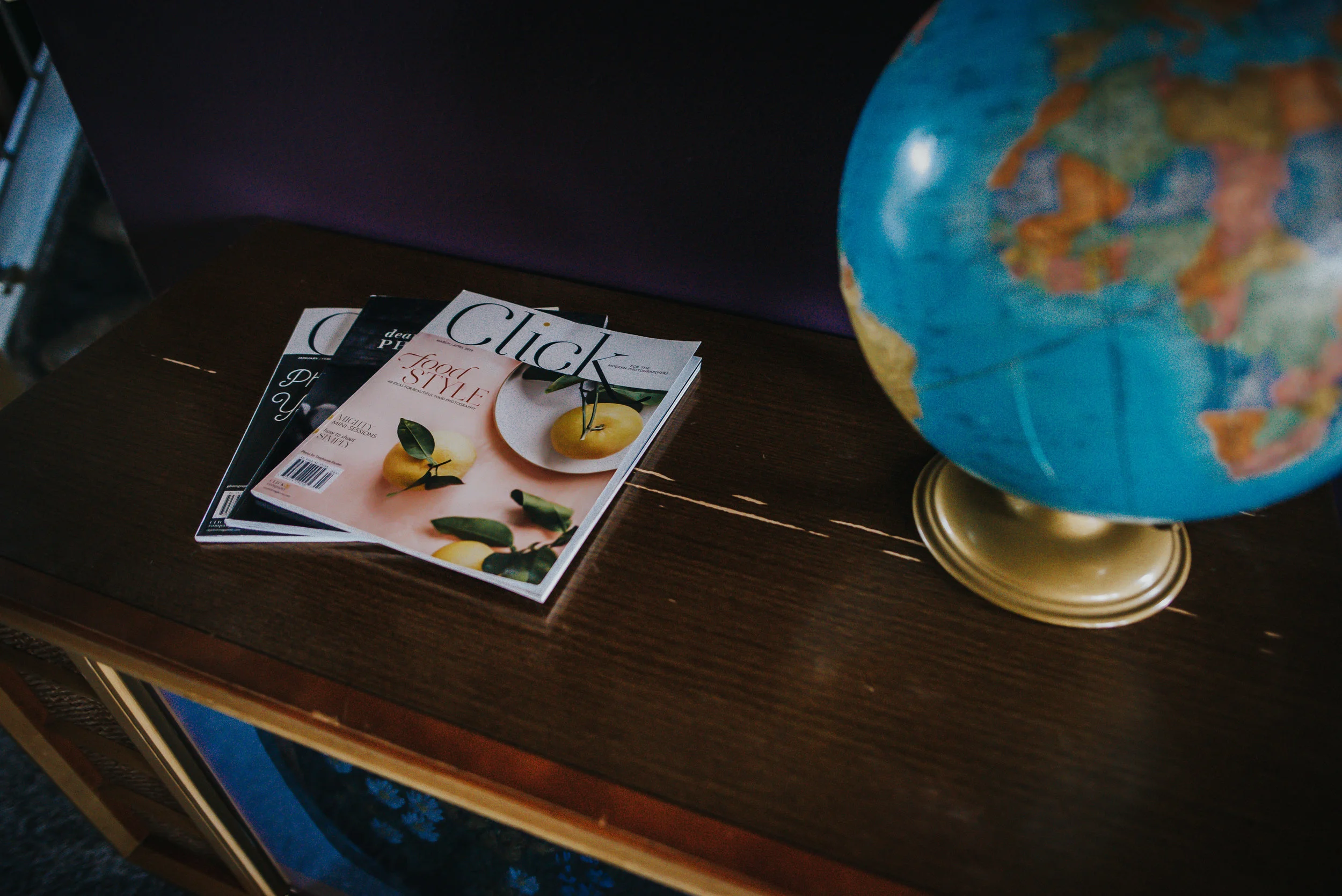 Click and Company as well as Dear Photographer magazines on vintage television set in livingroom.