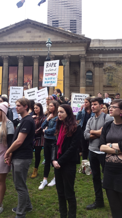Men and women listening to the speeches outside the State Library 