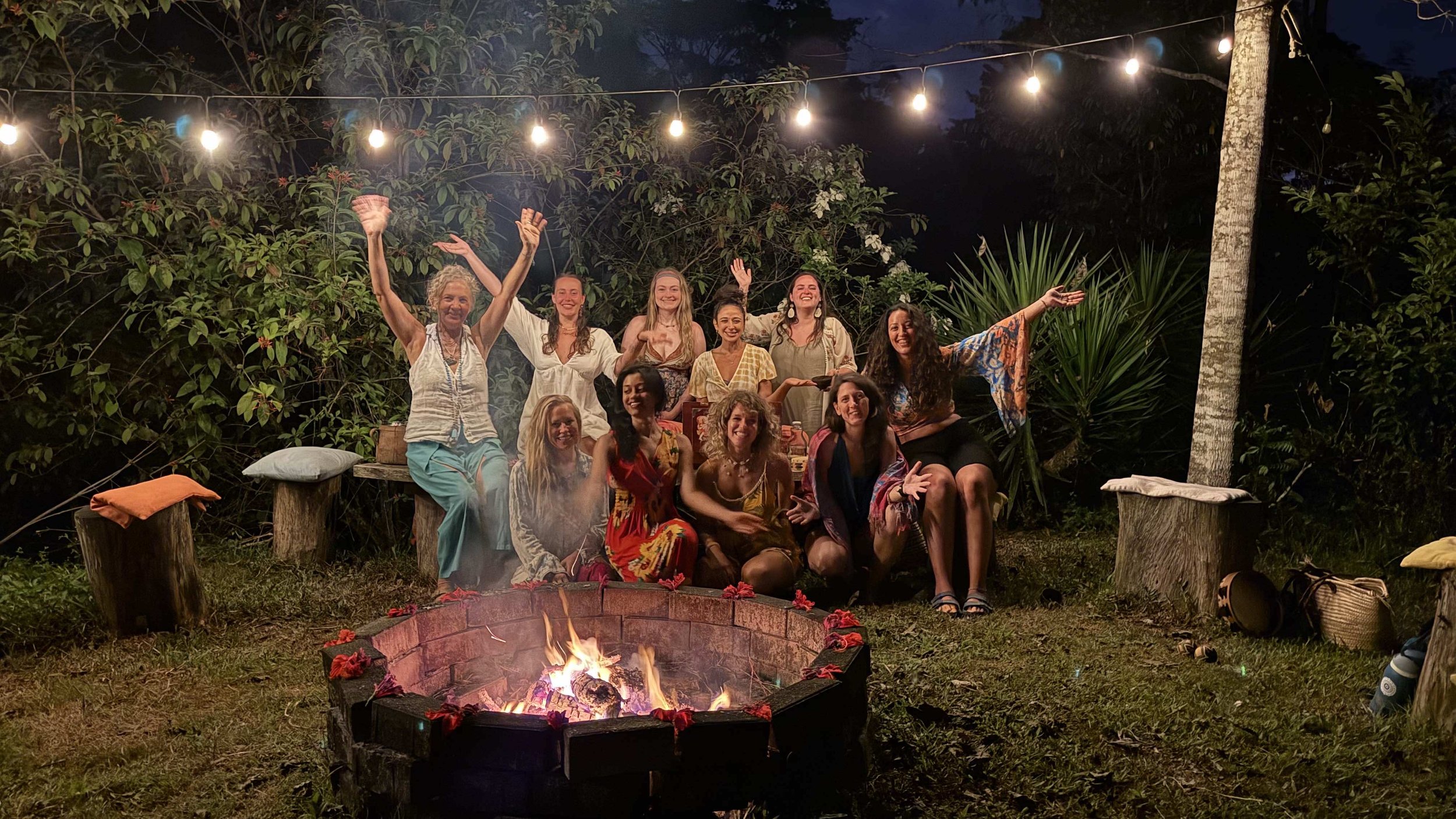 A group of people waving by a fire
