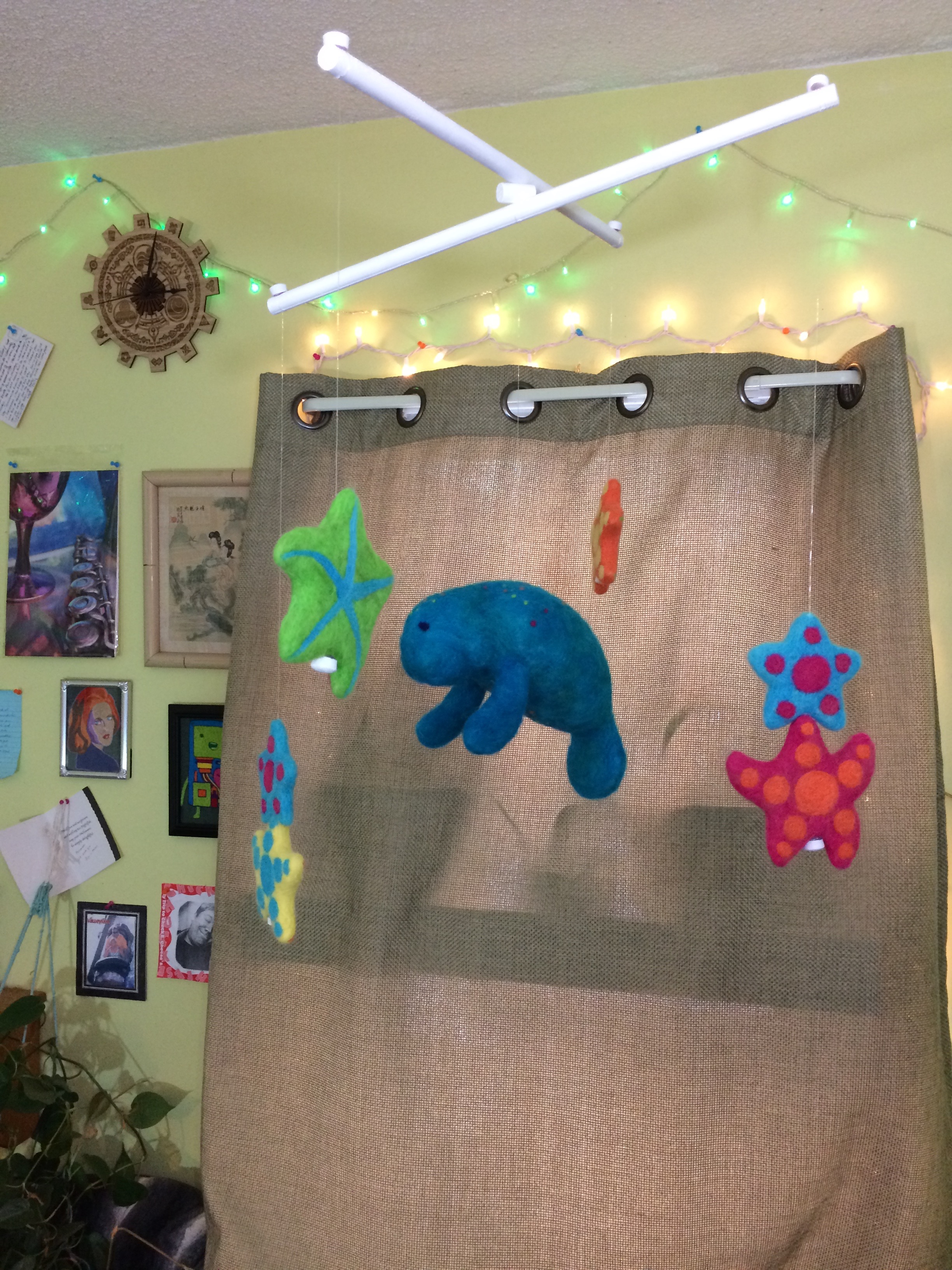 Crib Mobile made of needle-felted sea creatures: starfish and manatee.
