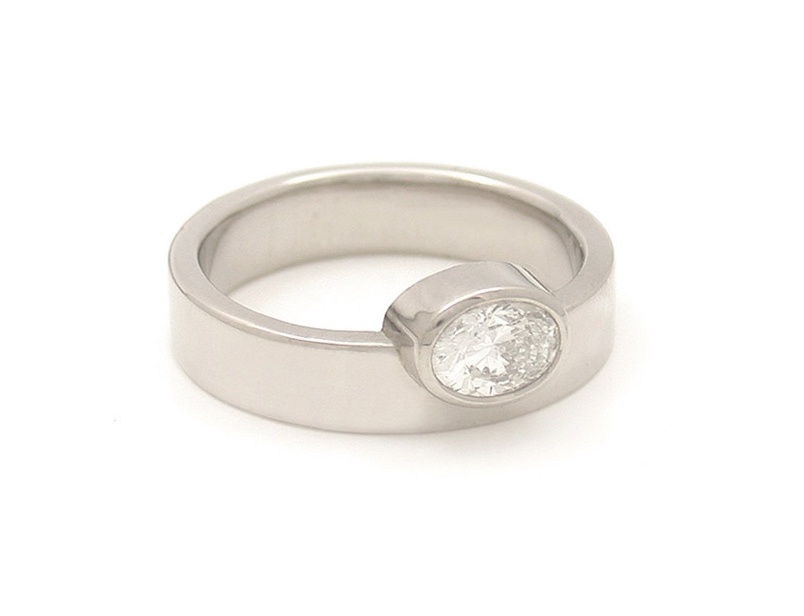 off-side-asymmetric-bezel-oval-diamond-solitaire-engagement-ring.jpg