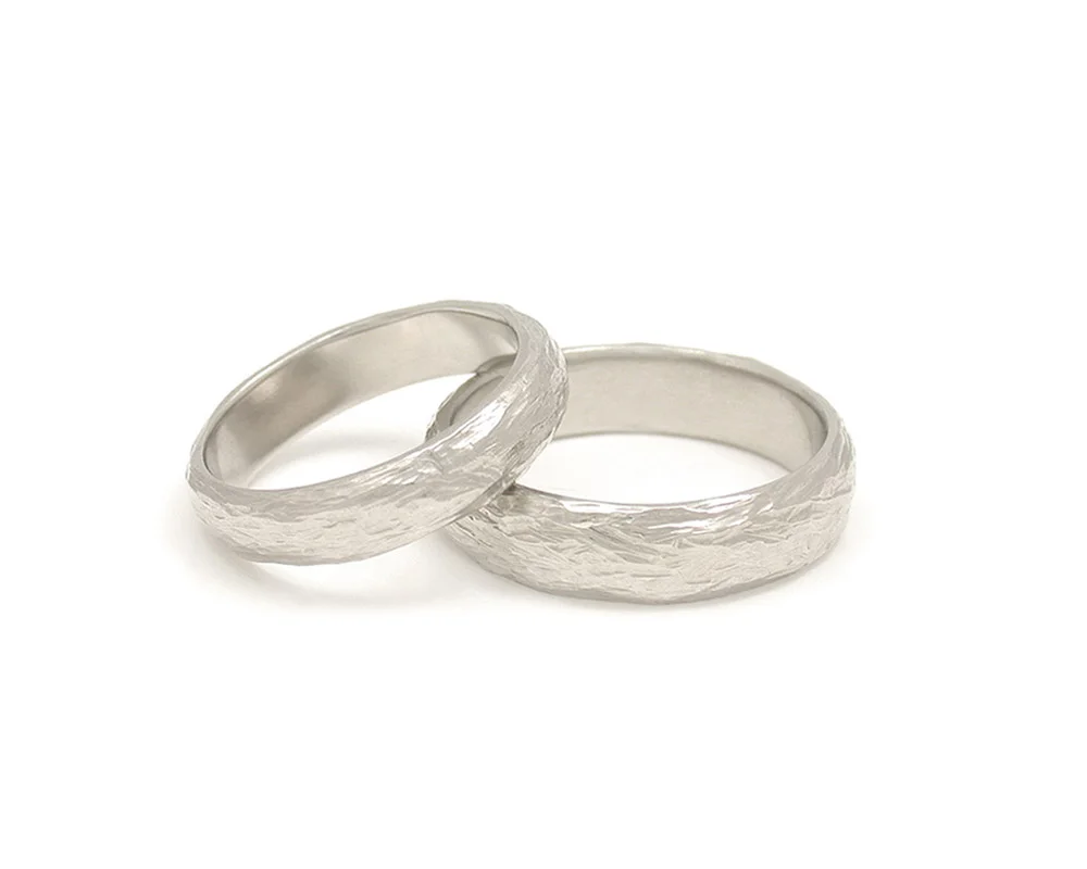 rounded-surface-tree-bark-texture-handmade-whie-gold-wedding-band-rings.jpg