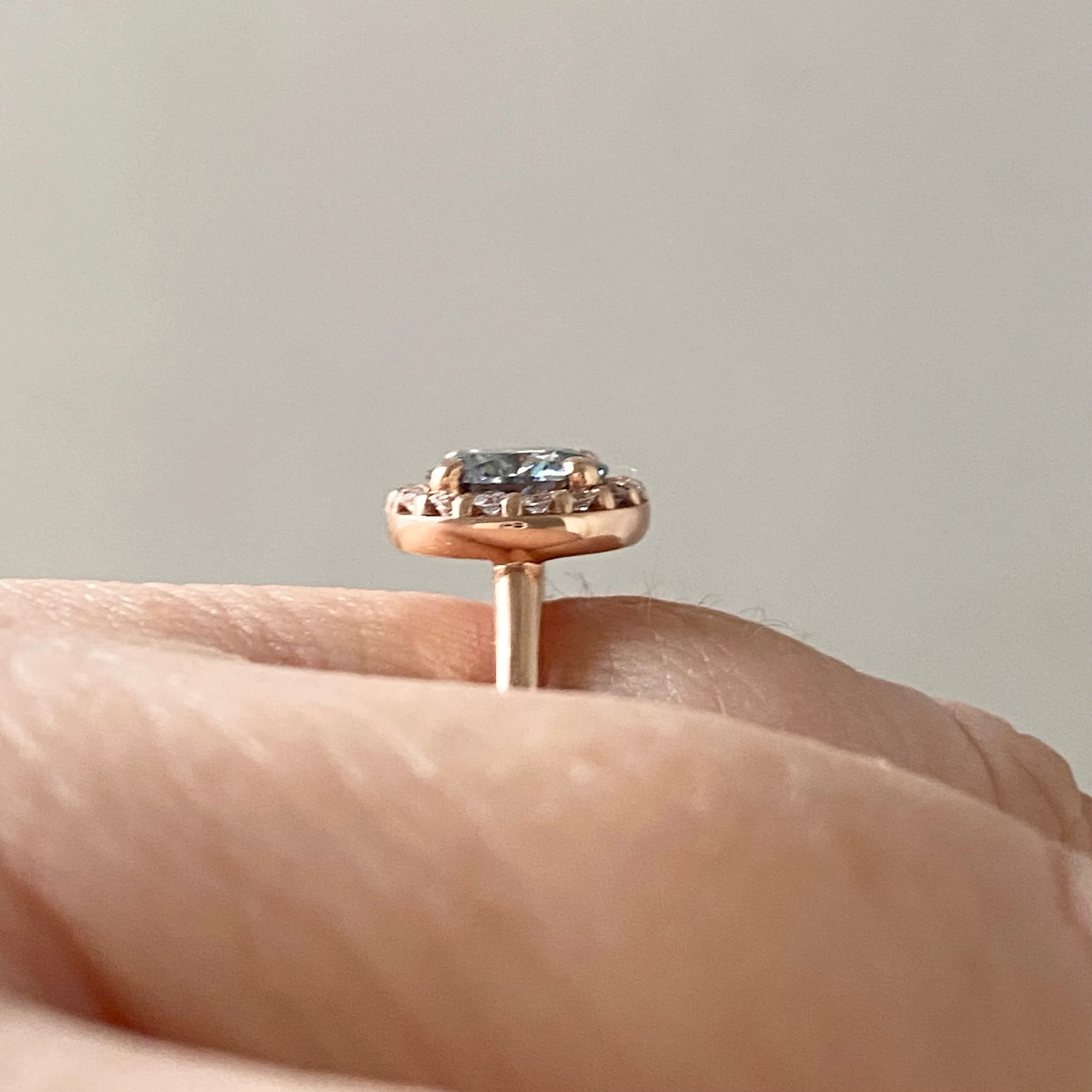 round brilliant cut grey moissanite canadian diamond halo 14k rose gold engagement ring side view Kim Drosdick Jewellery