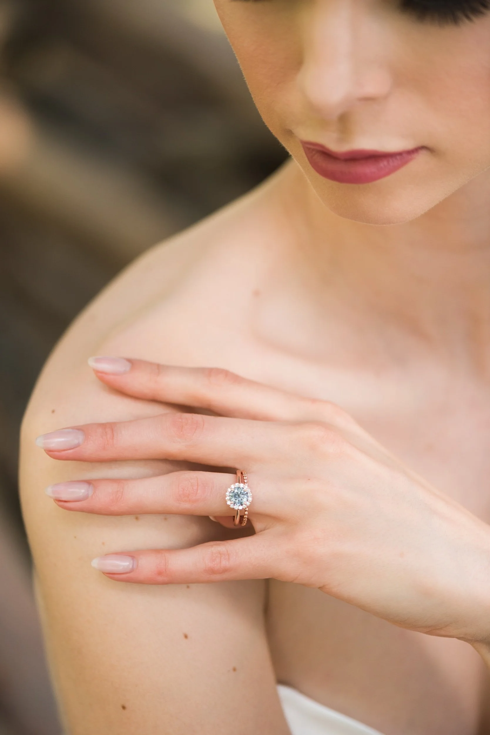 round brilliant cut grey moissanite canadian diamond halo 14k rose gold engagement ring on hand with wedding ring Kim Drosdick Jewellery