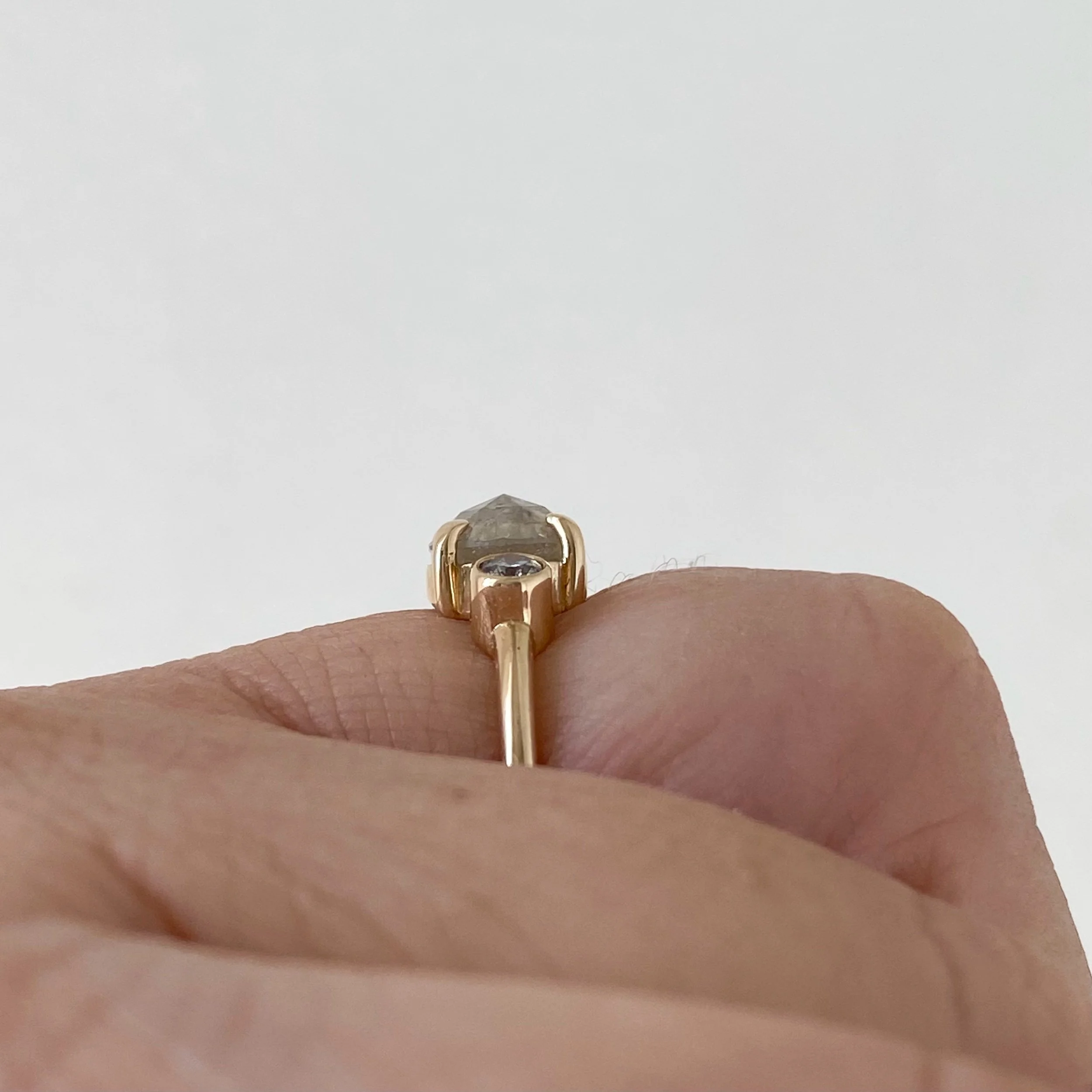 tone engagement ring with bezel set sides 14k yellow gold side view on hand Kim Drosdick Jewellery Toronto