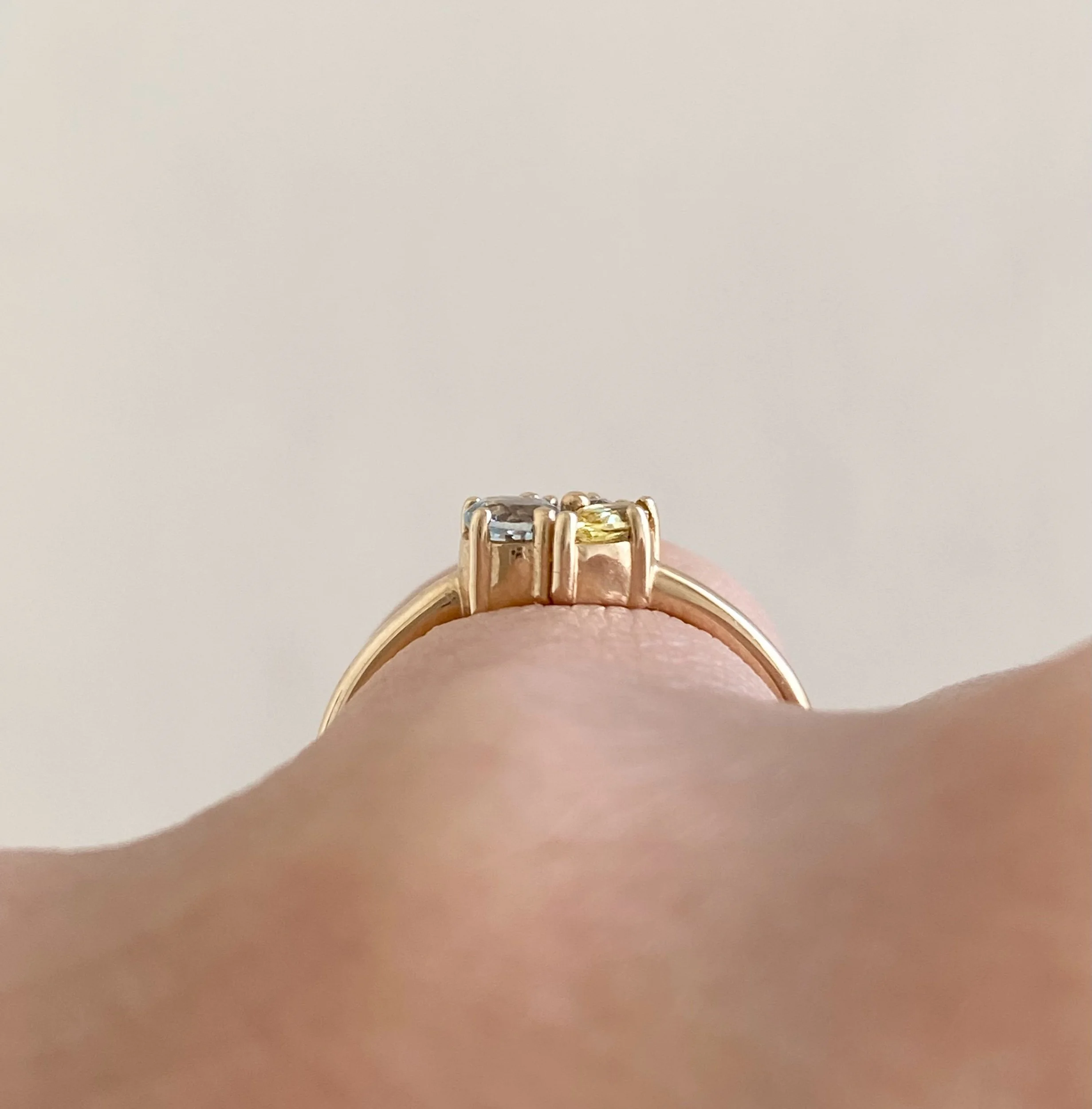three stone cluster ring in 14k recycled yellow gold using aquamarine diamond and yellow sapphire on hand side view