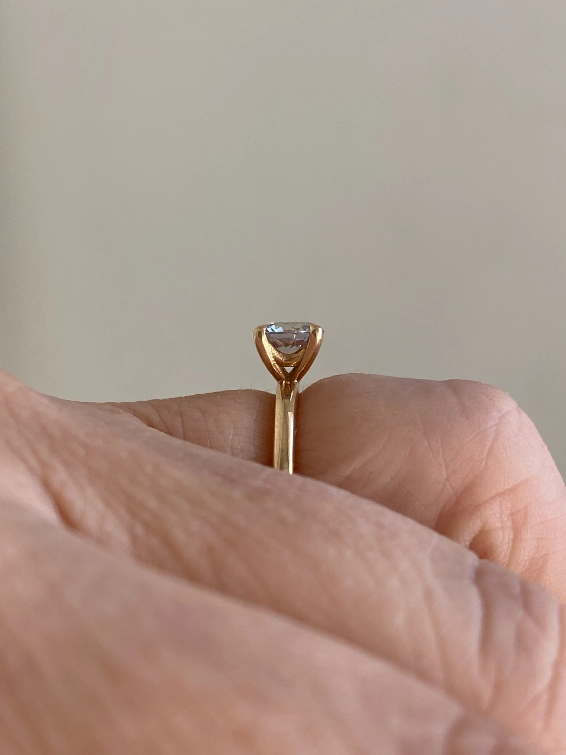 greige sapphire solitaire 14k yellow gold engagement ring toronto Kim Drosdick jewellery on hand side view