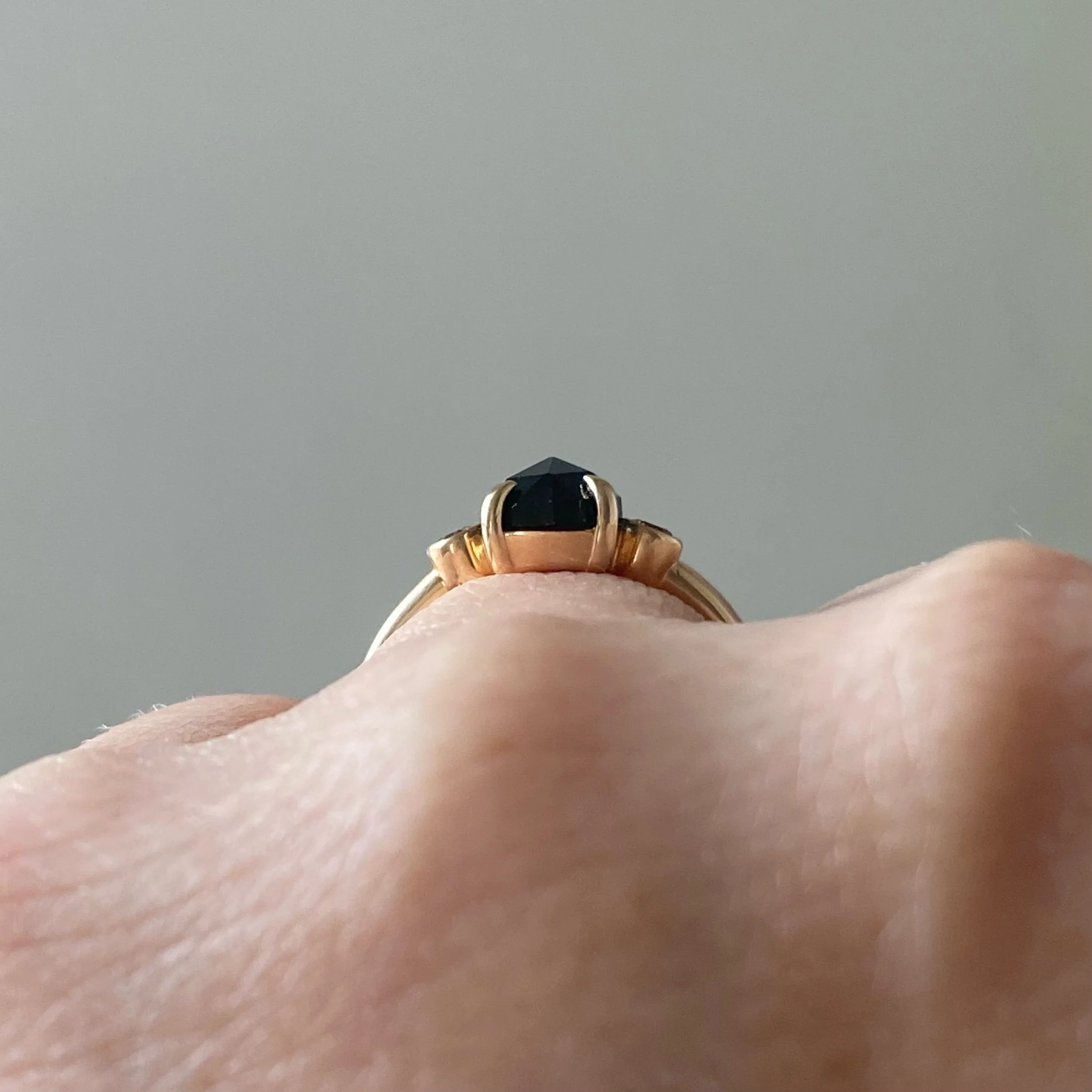rose cut blue oval sapphire 3-stone champagne diamond alternative engagement ring 14k yellow gold bezel set claw set rounded band Kim Drosdick Jewellery Toronto  on hand side view