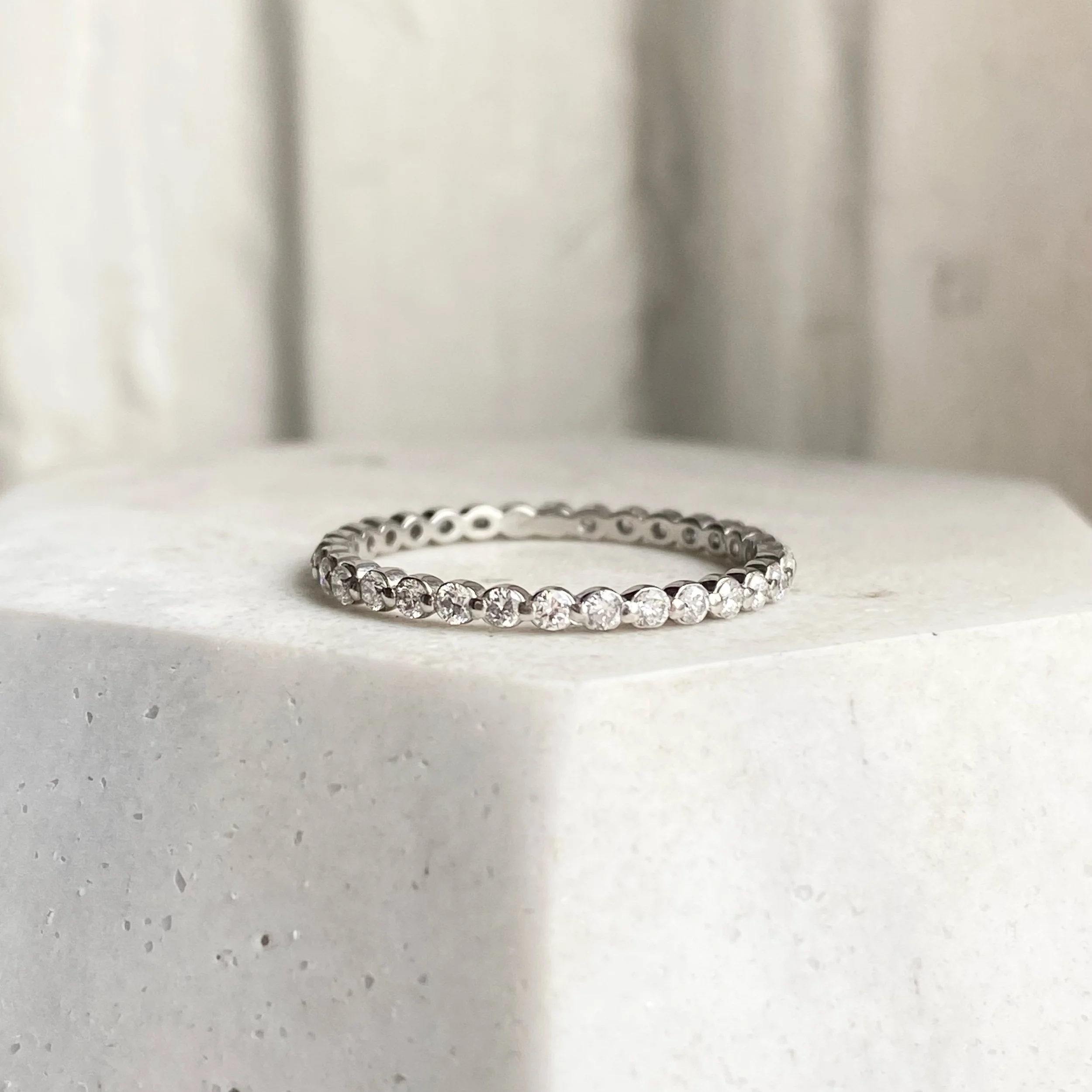 lab diamond and platinum eternity wedding stacking ring shared single claw on prop