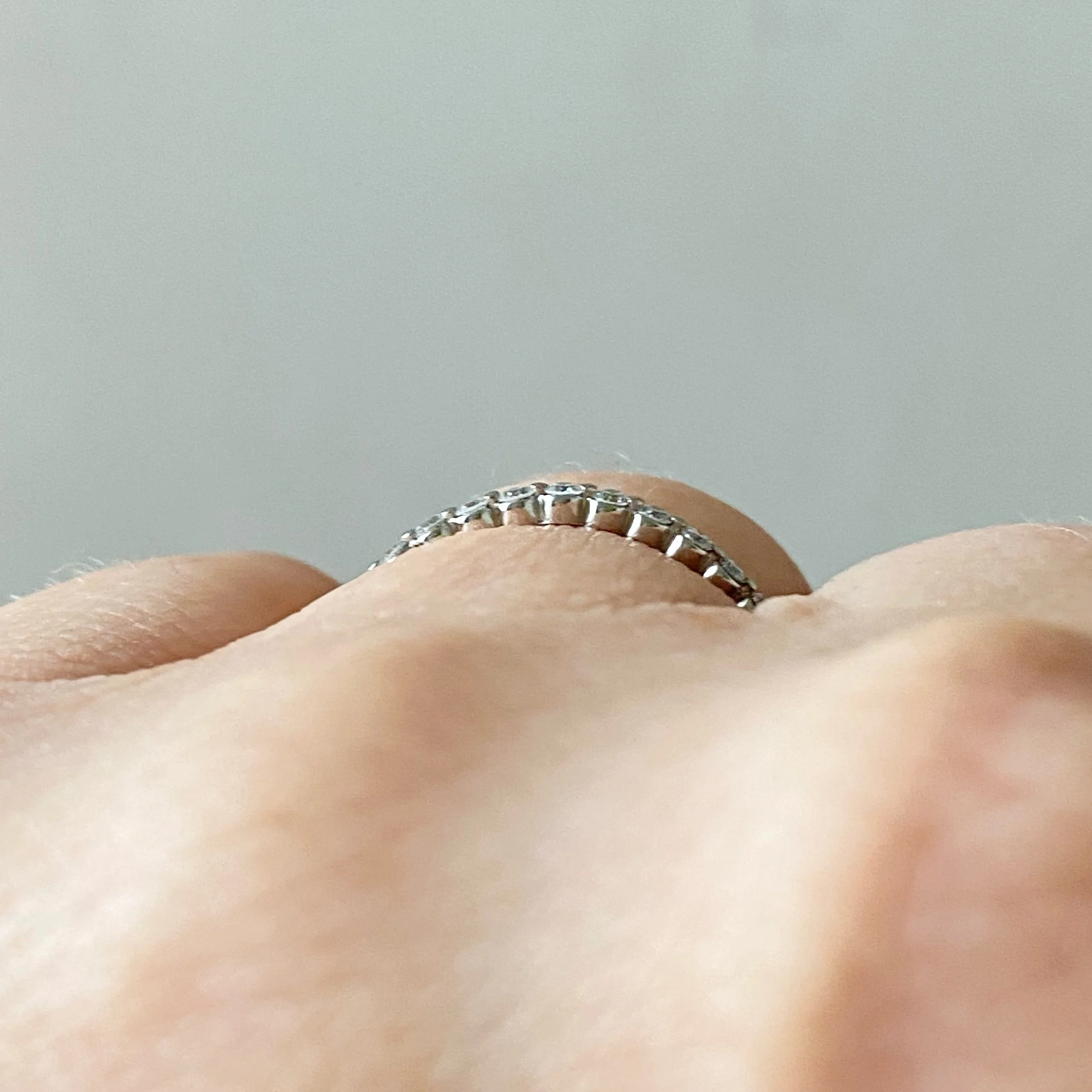 lab diamond and platinum eternity wedding stacking ring shared single claw on hand