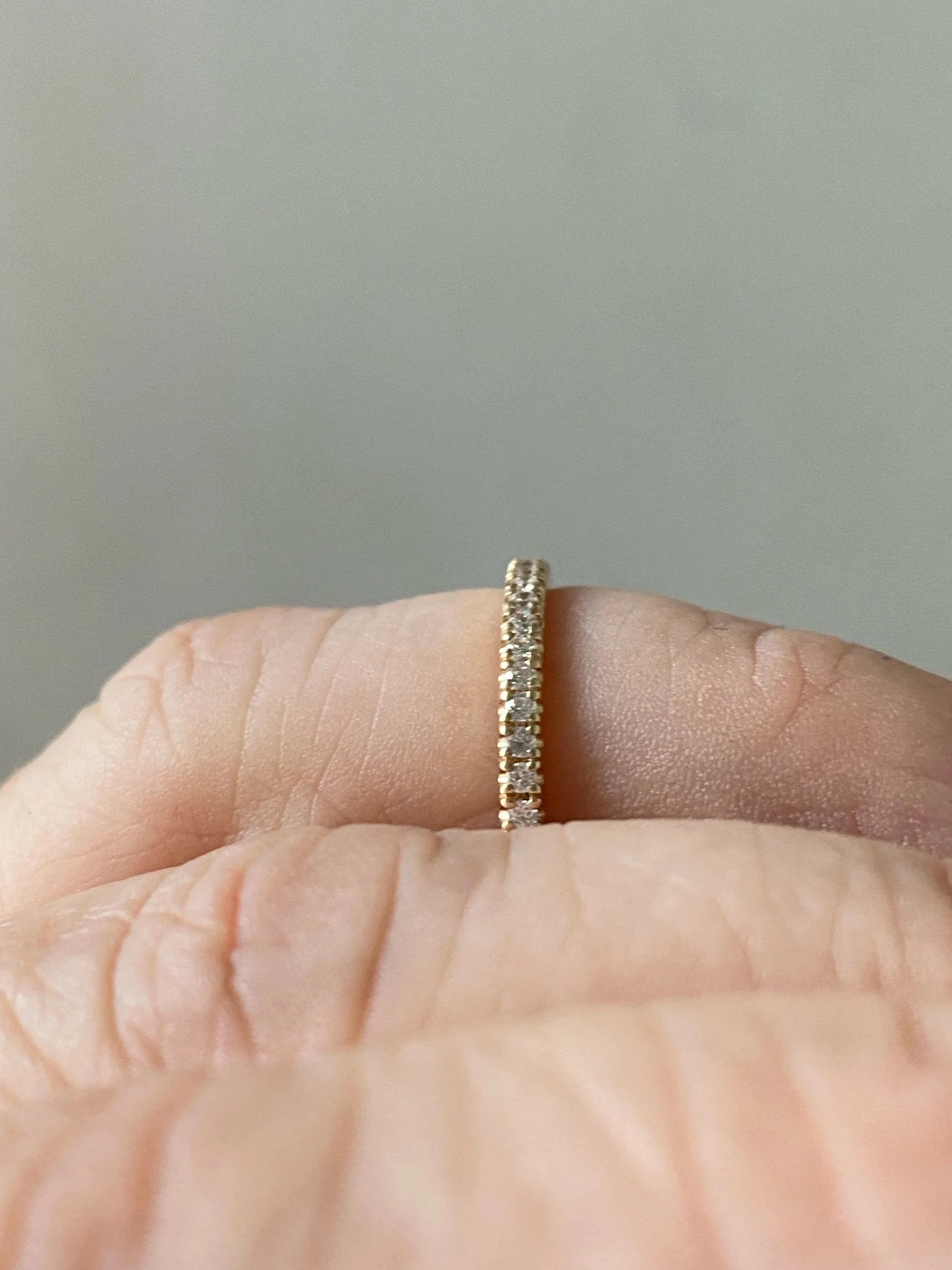 lab grown diamond french pave wedding band recycled 14k yellow gold on hand side view