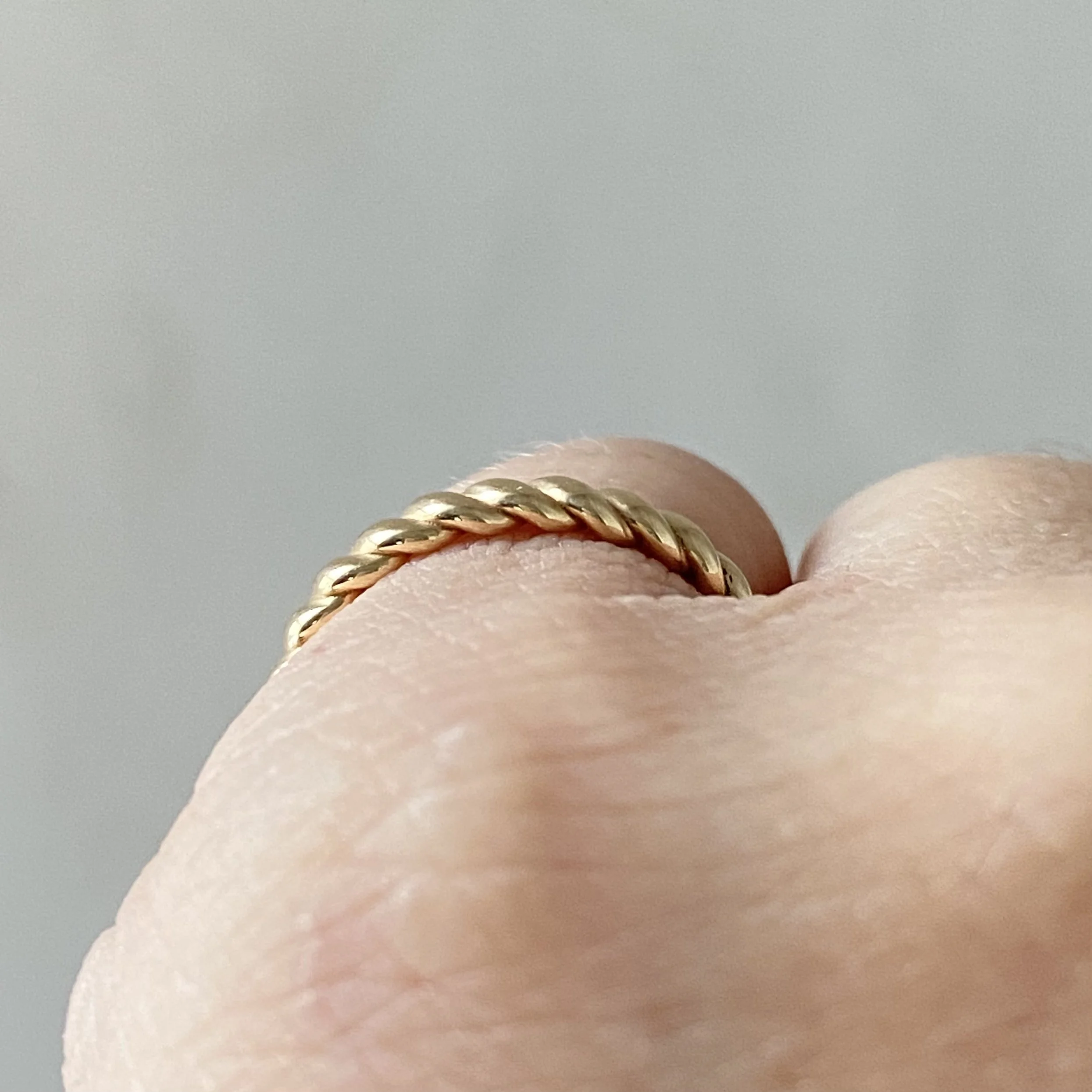 wide rope ring 14k recycled yellow gold stacking wedding ring through finger view Kim Drosdick jewellery Toronto (Copy)