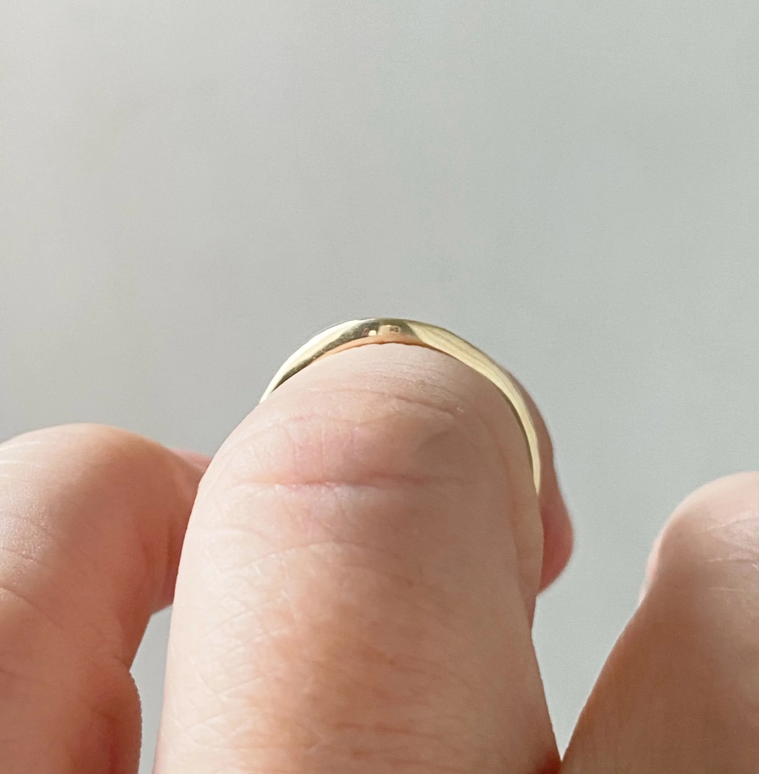 narrow hammered recycled 14k yellow gold contour wedding ring stacking band polished on hand through finger view boho organic vintage kim drosdick toronto