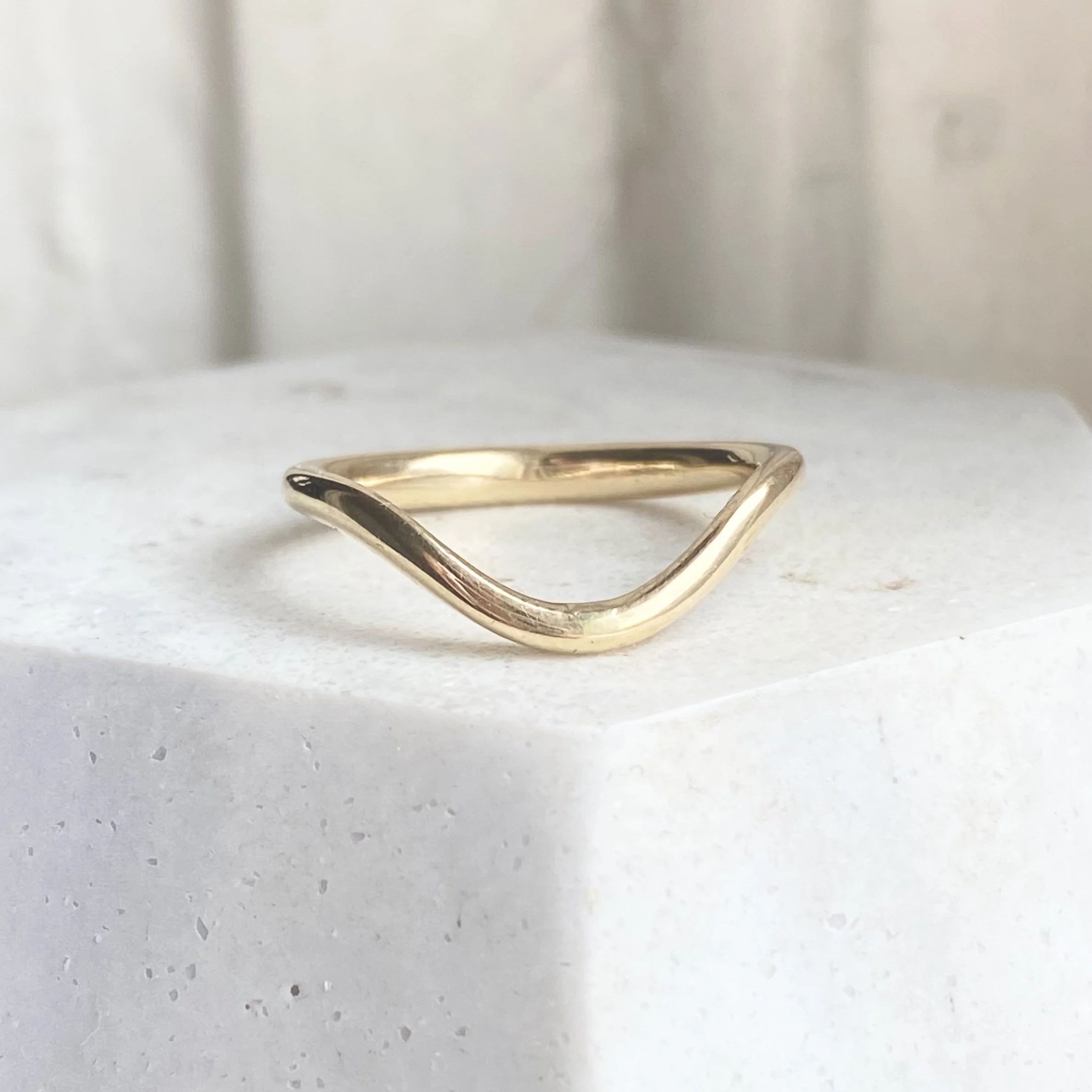 deep contour wedding ring 14k yellow recycled gold modern curved on dish kim drosdick toronto