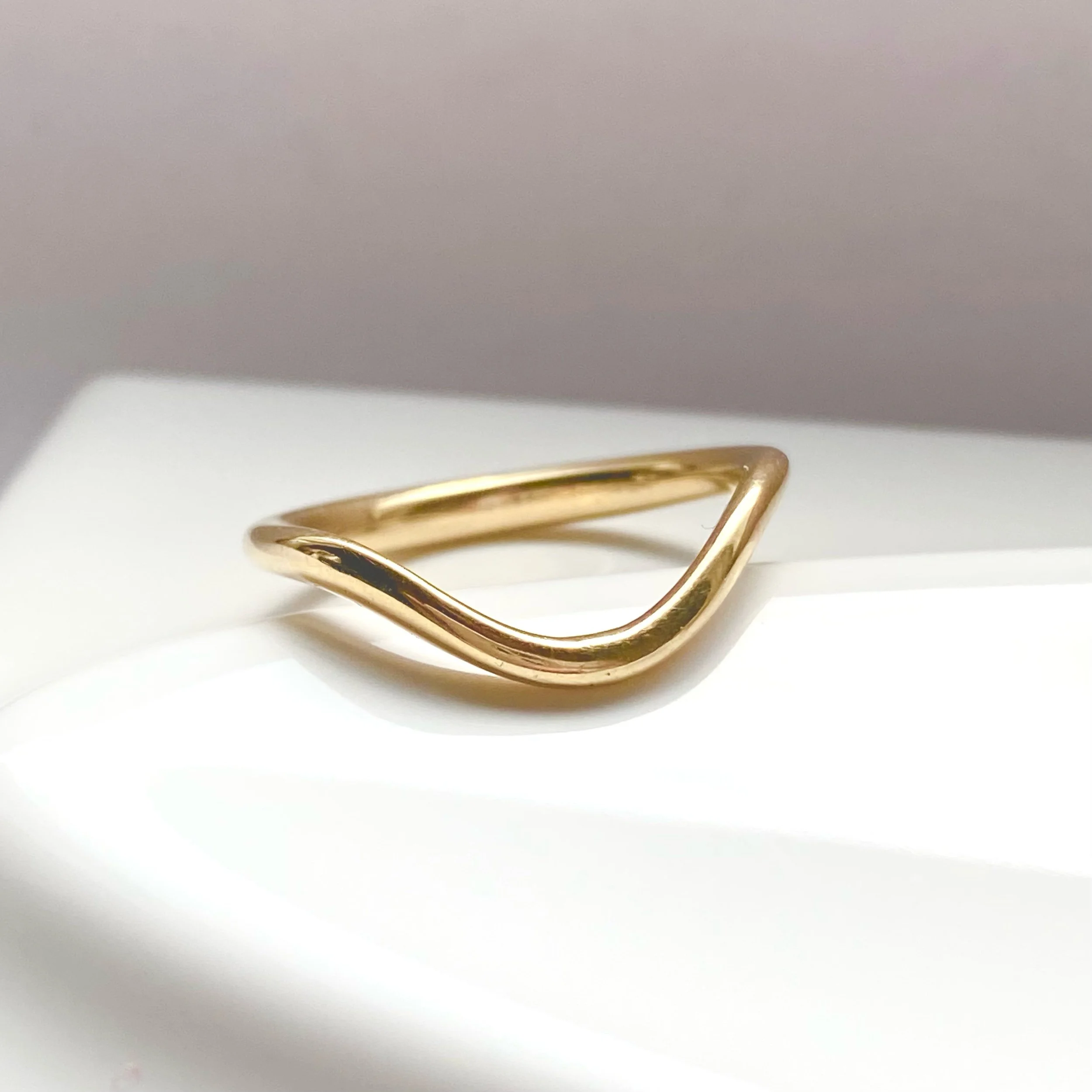 deep contour wedding ring 14k yellow recycled gold modern curved on dish kim drosdick toronto