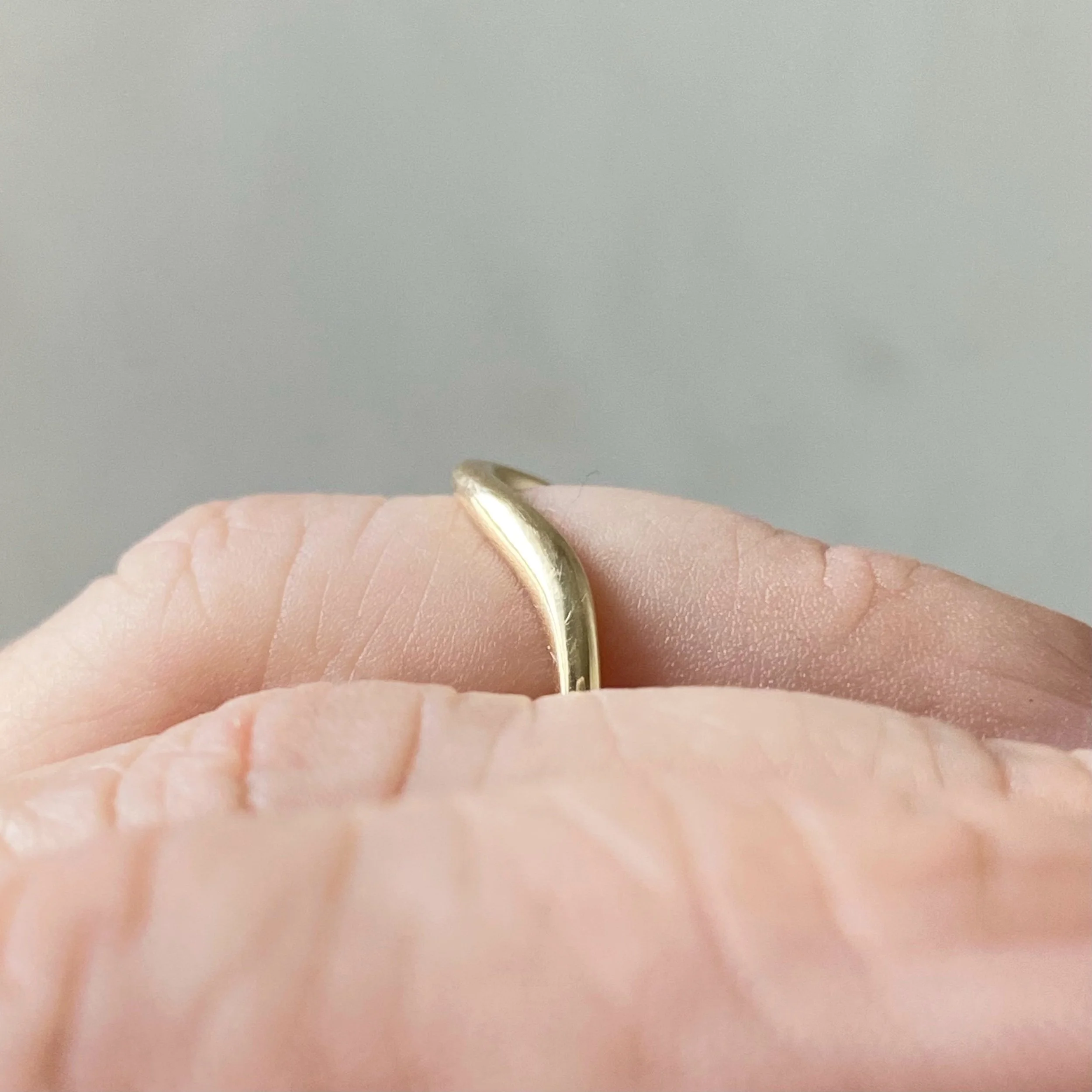 deep contour wedding ring 14k yellow recycled gold modern curved on hand side view kim drosdick toronto