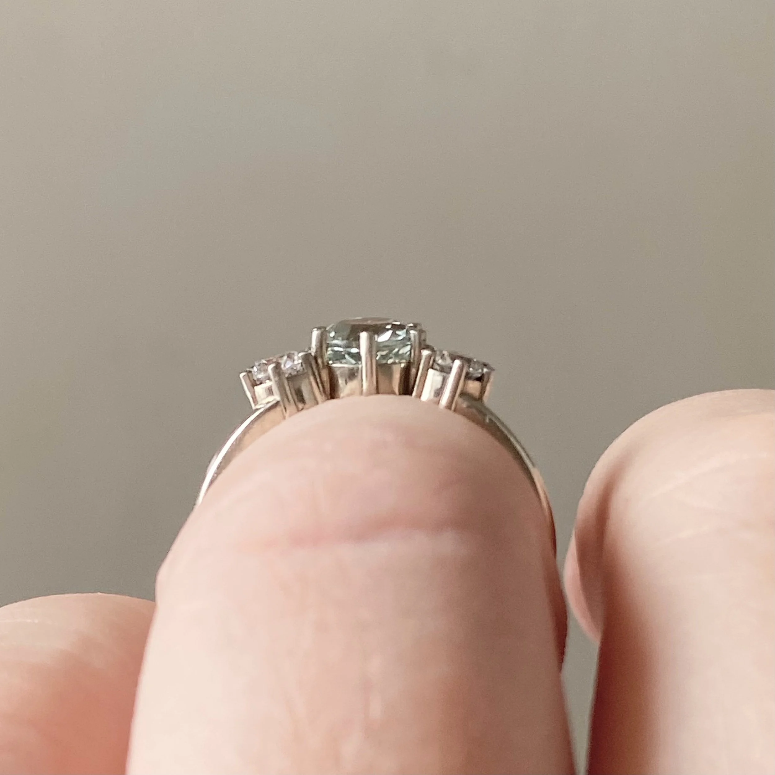 bette davis ring minty green lab grown sapphire with side ab diamonds flush edge engagement ring 14k recycled white gold side view on hand Kim Drosdick custom Jewellery