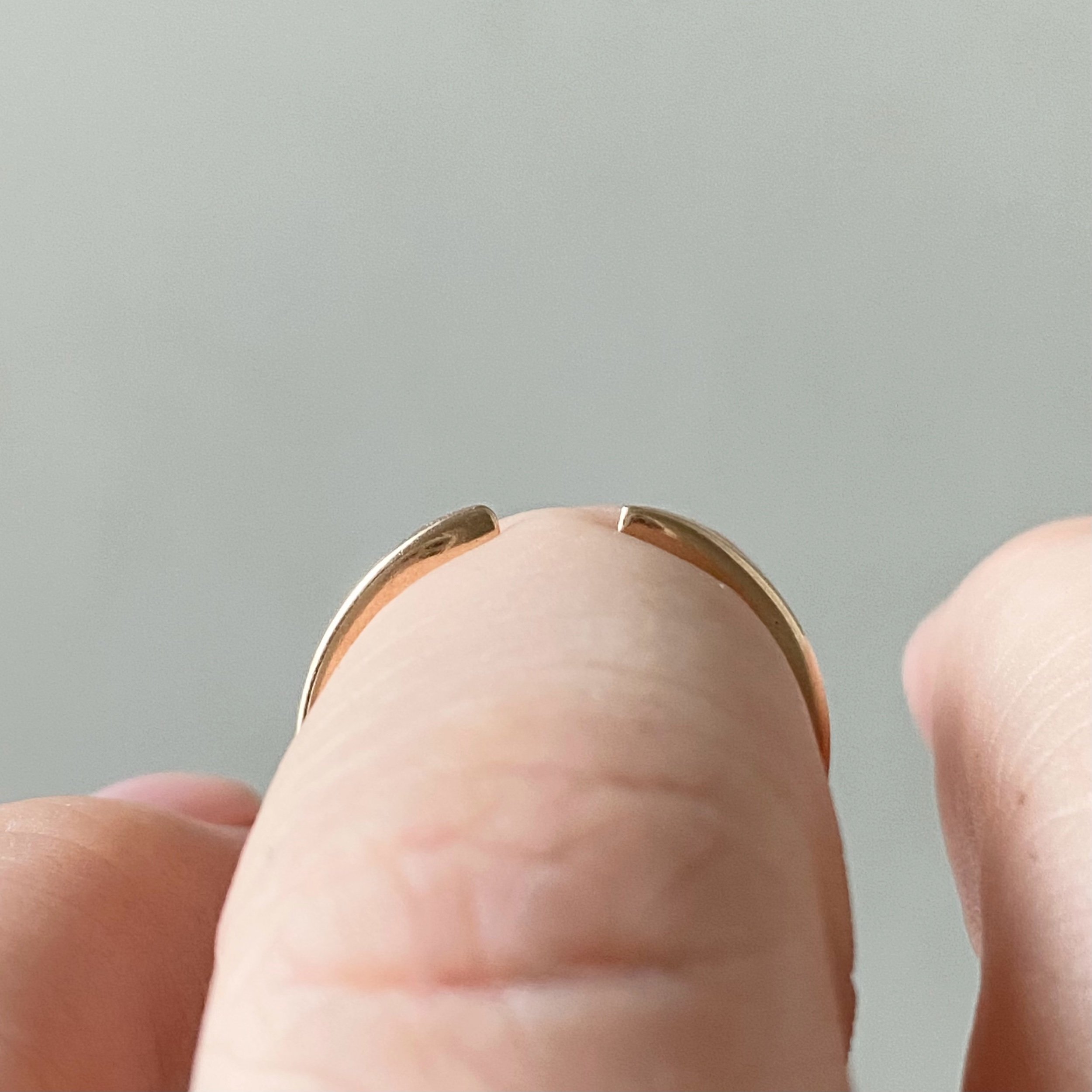 open design wedding stacking ring 14k recycled rose gold rounded narrow band through finger view on hand Kim Drosdick Toronto