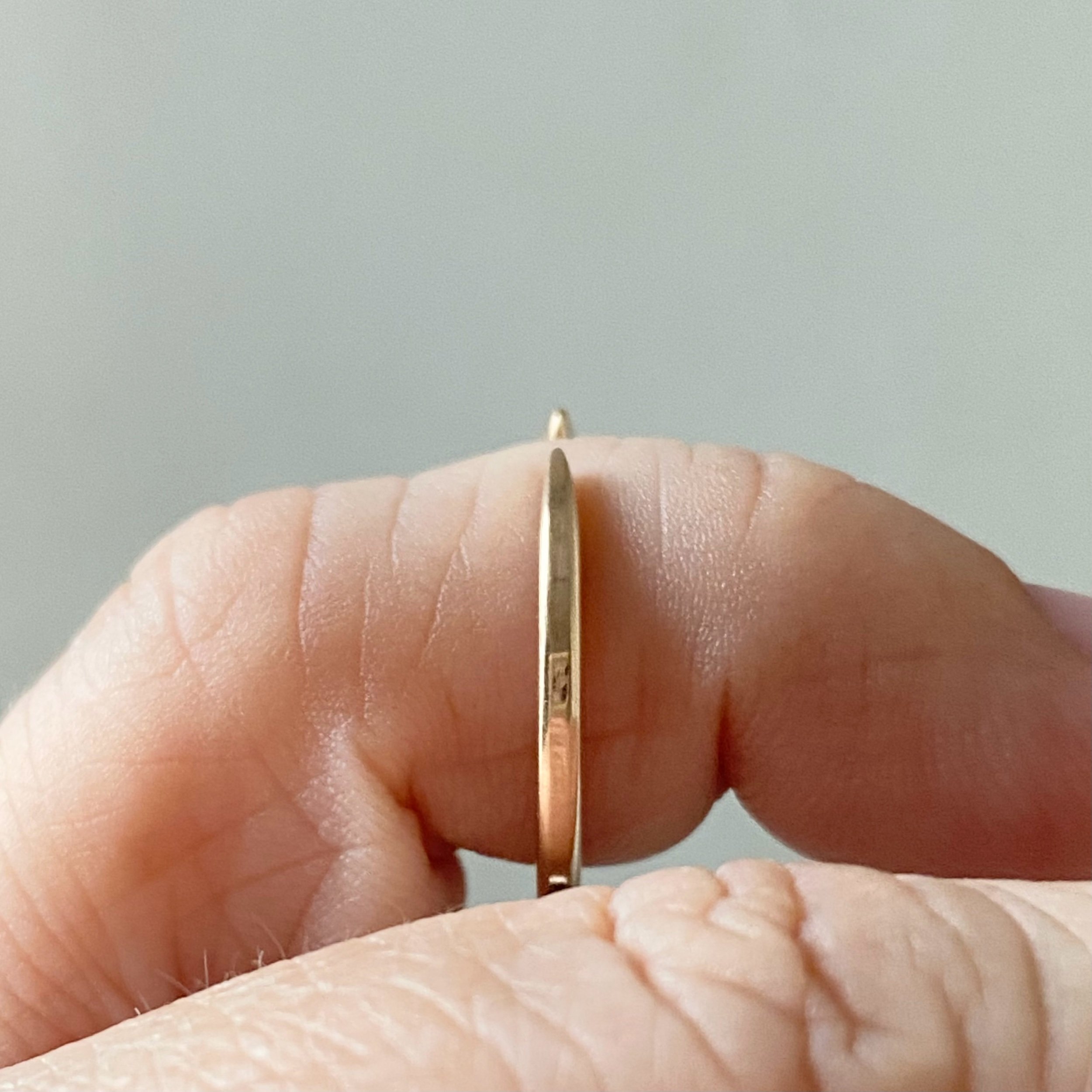 open design wedding stacking ring 14k recycled rose gold rounded narrow band side view on hand Kim Drosdick Toronto