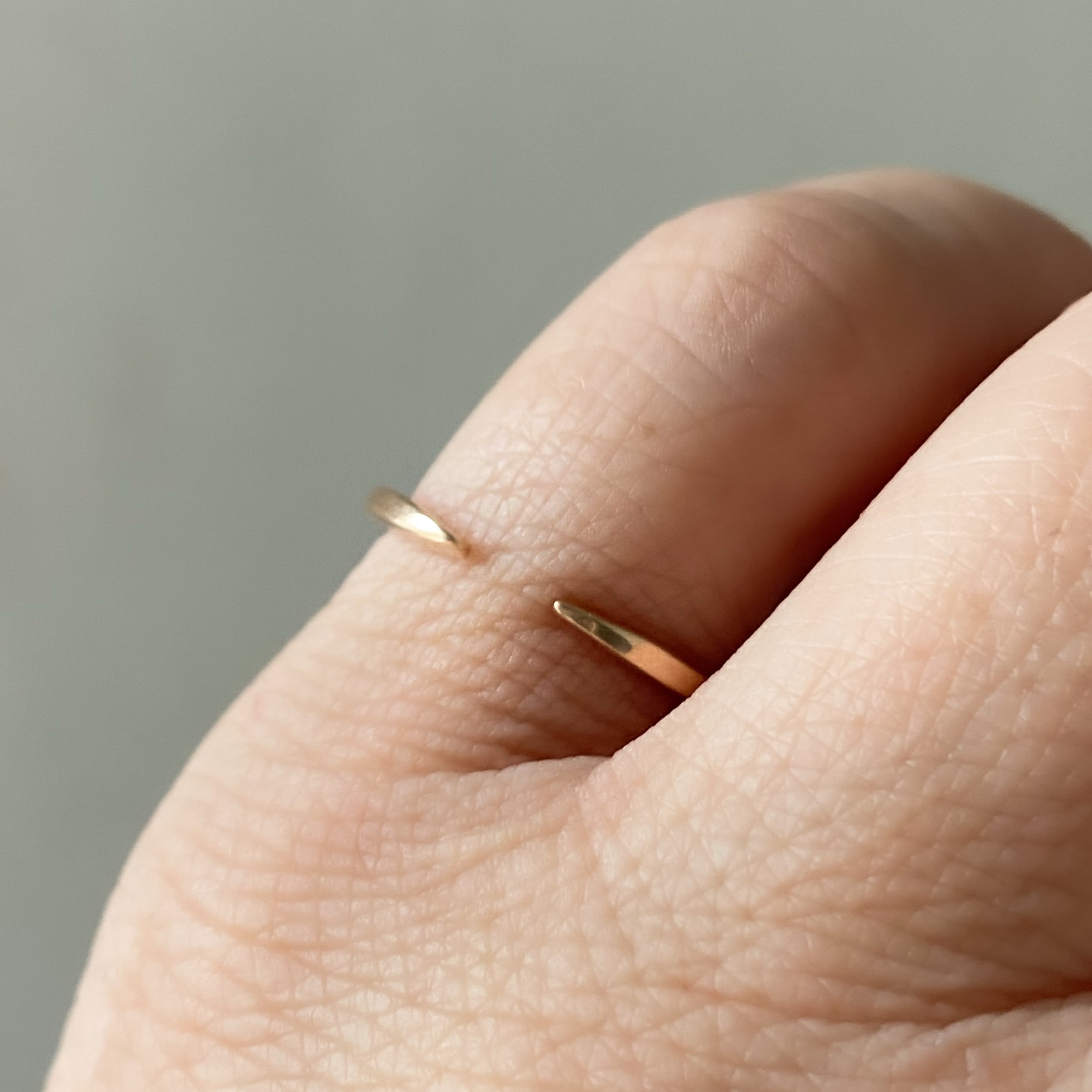 open design wedding stacking ring 14k recycled rose gold rounded narrow band through finger view on hand Kim Drosdick Toronto