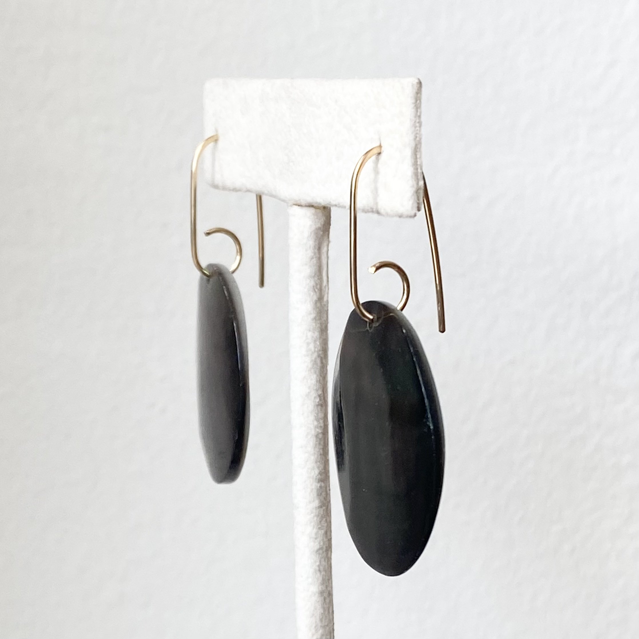 black mother of pearl earrings on earring stand Kim Drosdick Jewellery Toronto side view