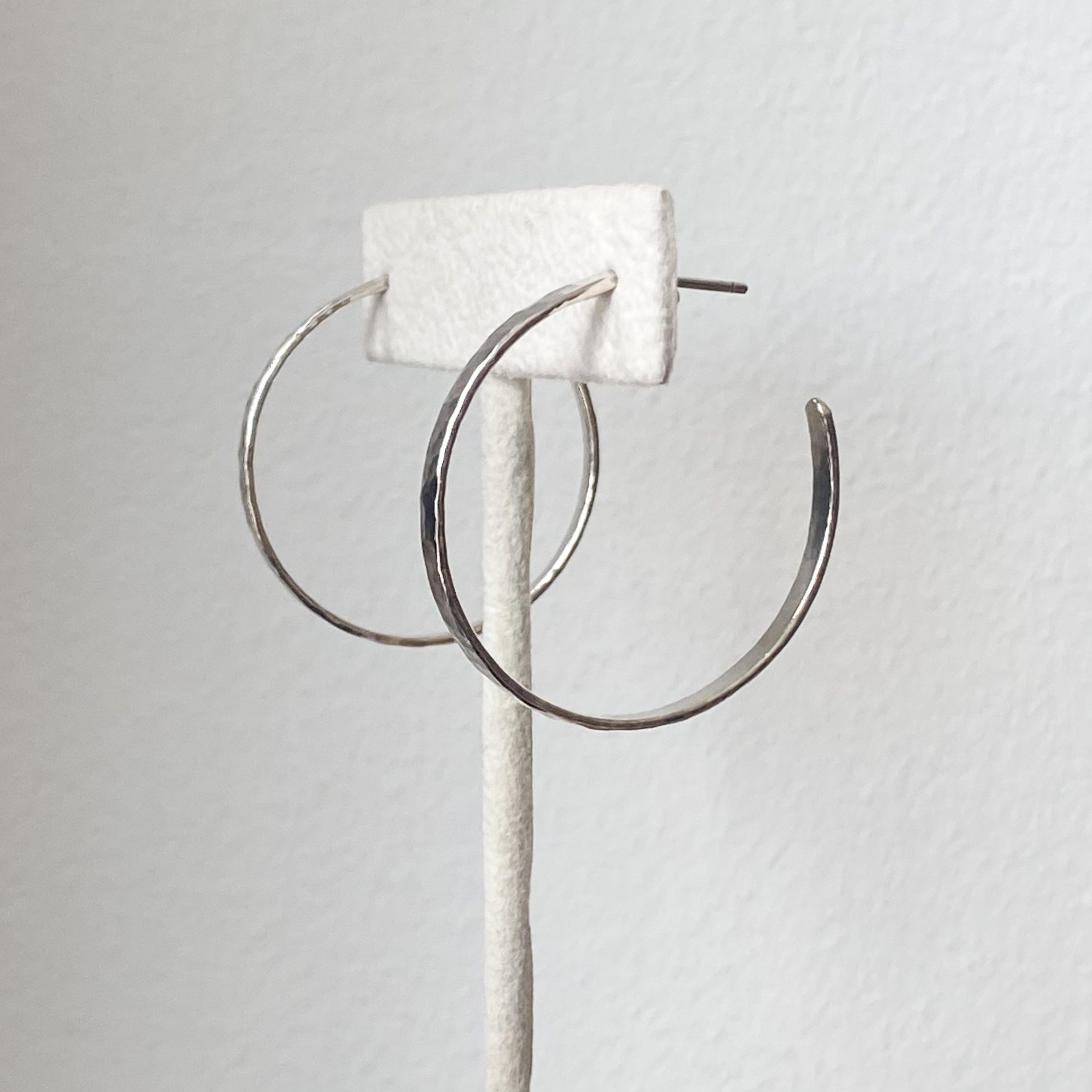 sterling silver hammered hoop earrings on display Kim Drosdick Toronto side view