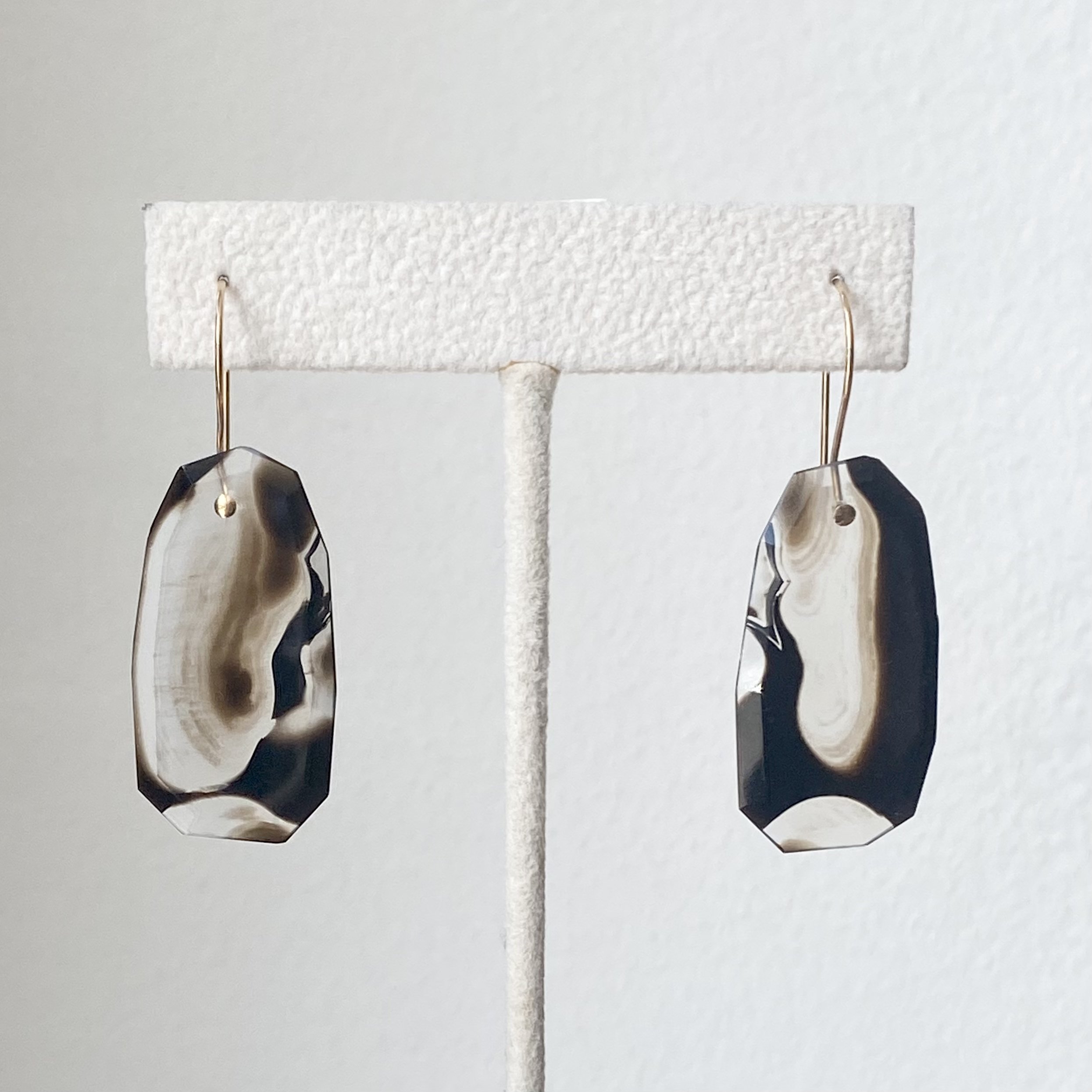 black agate colour banded transparent earthy hues dangly faceted earrings Kim Drosdick Toronto on stand