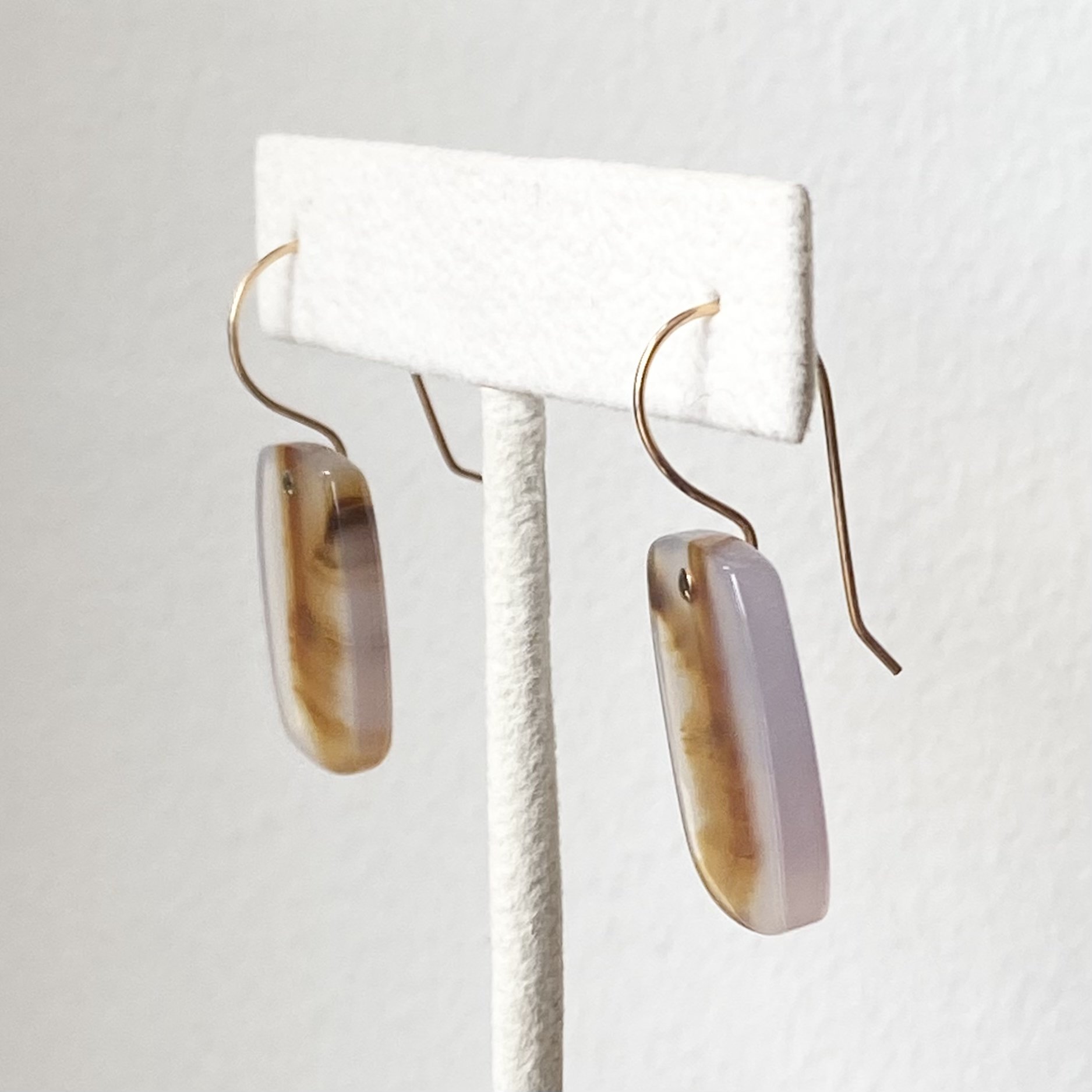 elongated cushion drop Montana agate earrings gold filed ear wires on stand side view Kim Drosdick jewellery Toronto