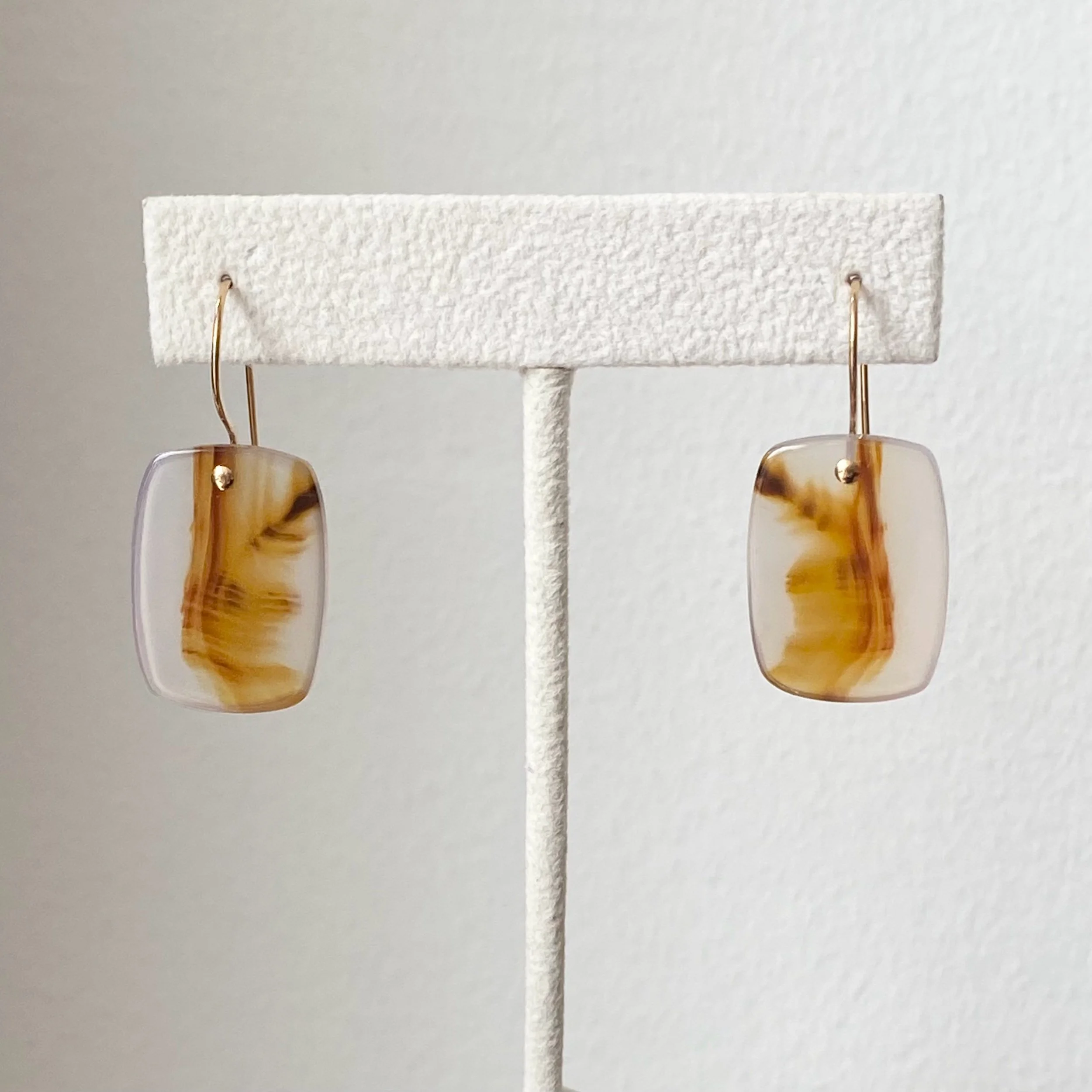 elongated cushion drop Montana agate earrings gold filed ear wires on stand front view Kim Drosdick jewellery Toronto