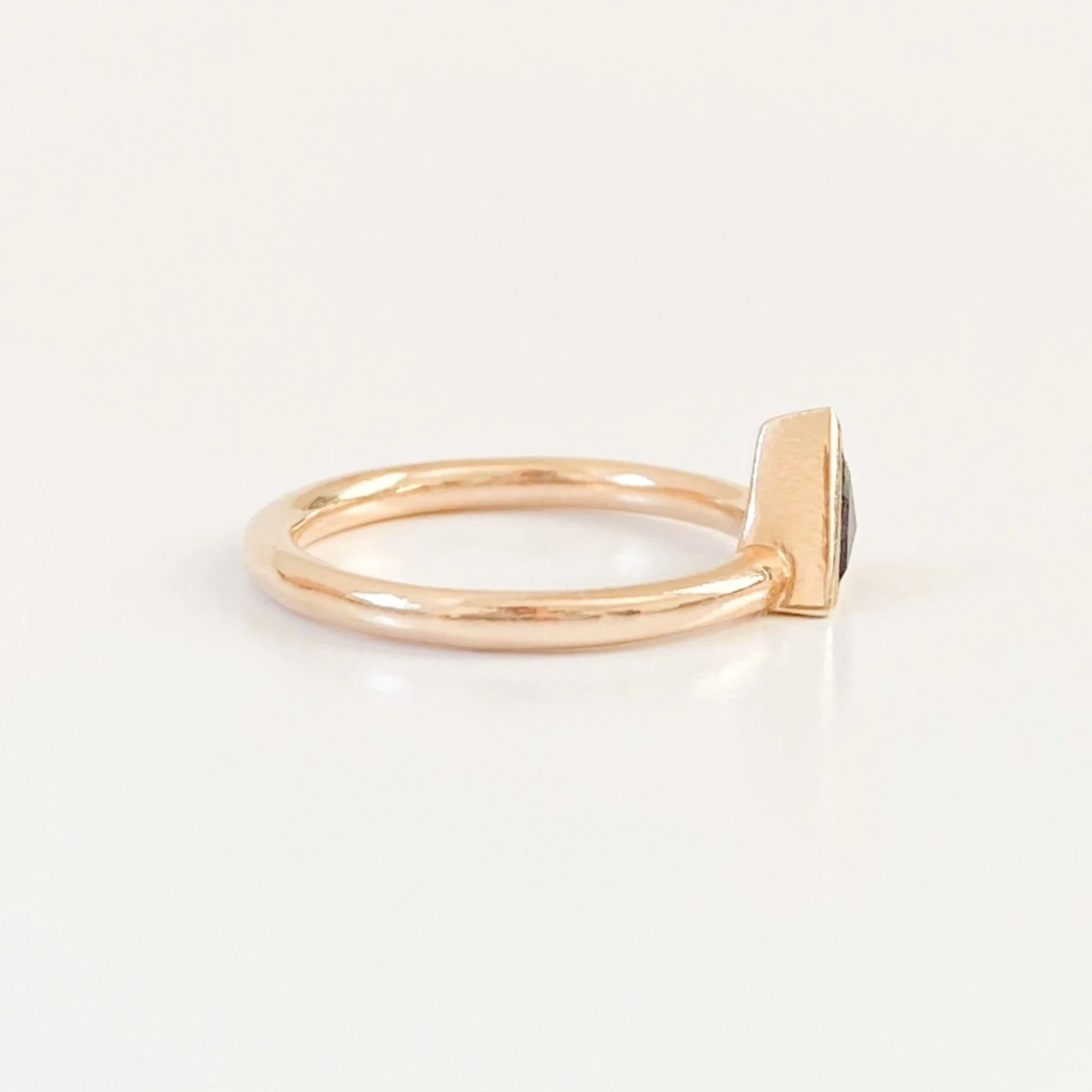 darker triangle salt and pepper diamond bezel set off side bottom justified to round wire band 14k yellow gold side view Kim Drosdick Jewellery Toronto