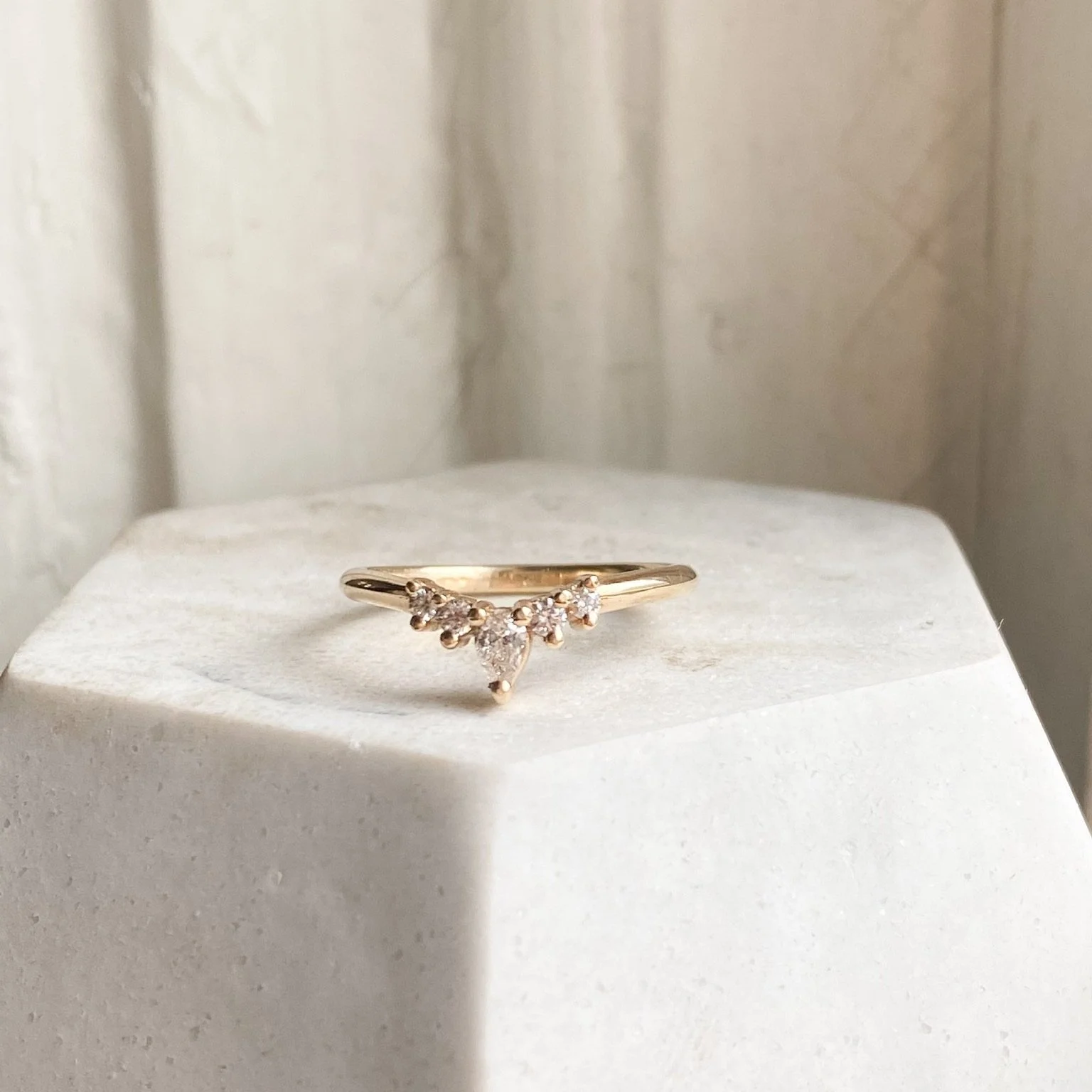 5 stone earth mined diamond tiara wedding ring pear and round shapes 14k recycled yellow gold on dish kim drosdick toronto