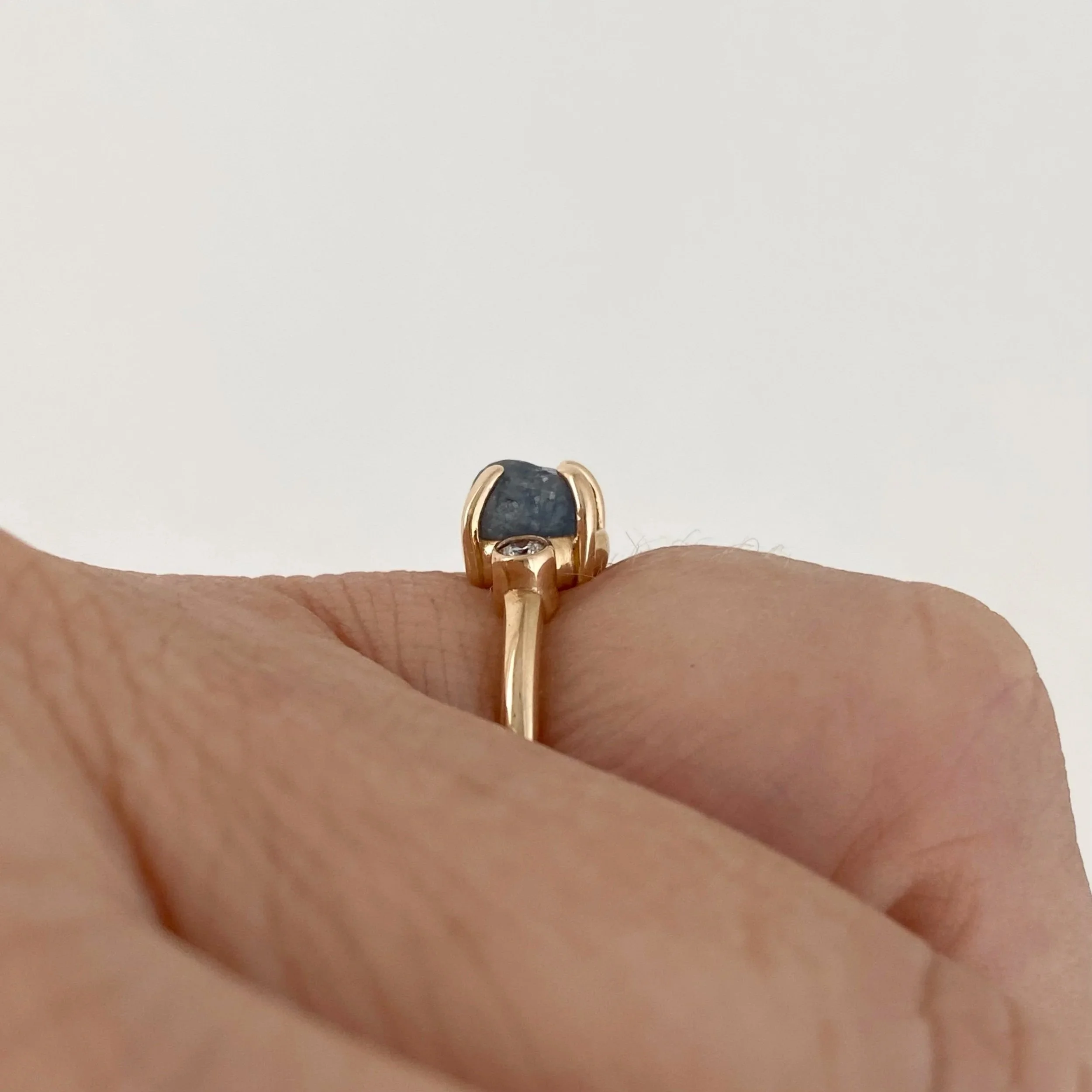 rough blue montana engagement ring claw set and bezel set side canadian diamonds 14k yellow gold side view on hand Kim Drosdick Jewellery Toronto