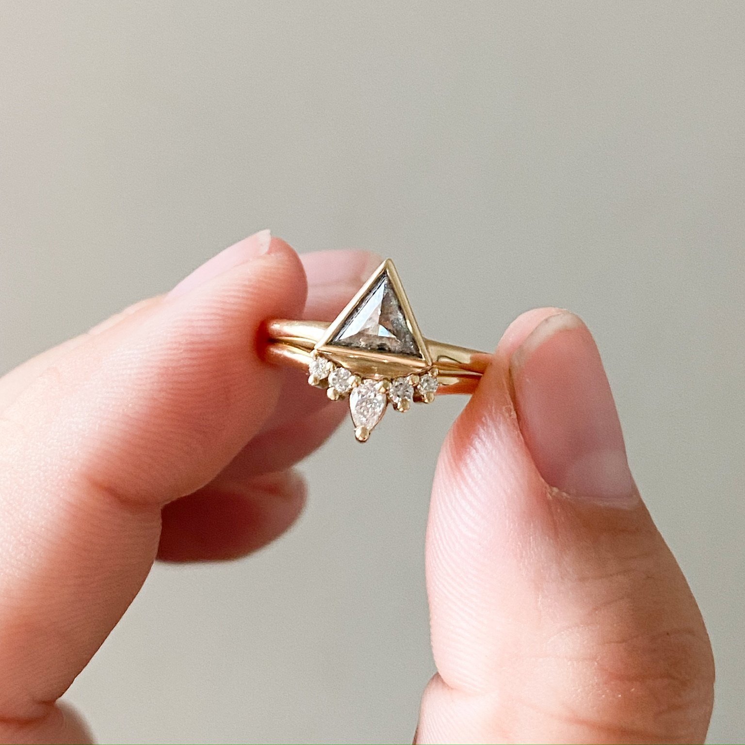5 stone earth mined diamond tiara wedding ring pear and round shapes 14k recycled yellow gold with pink stone engagement ring on hand kim drosdick toronto