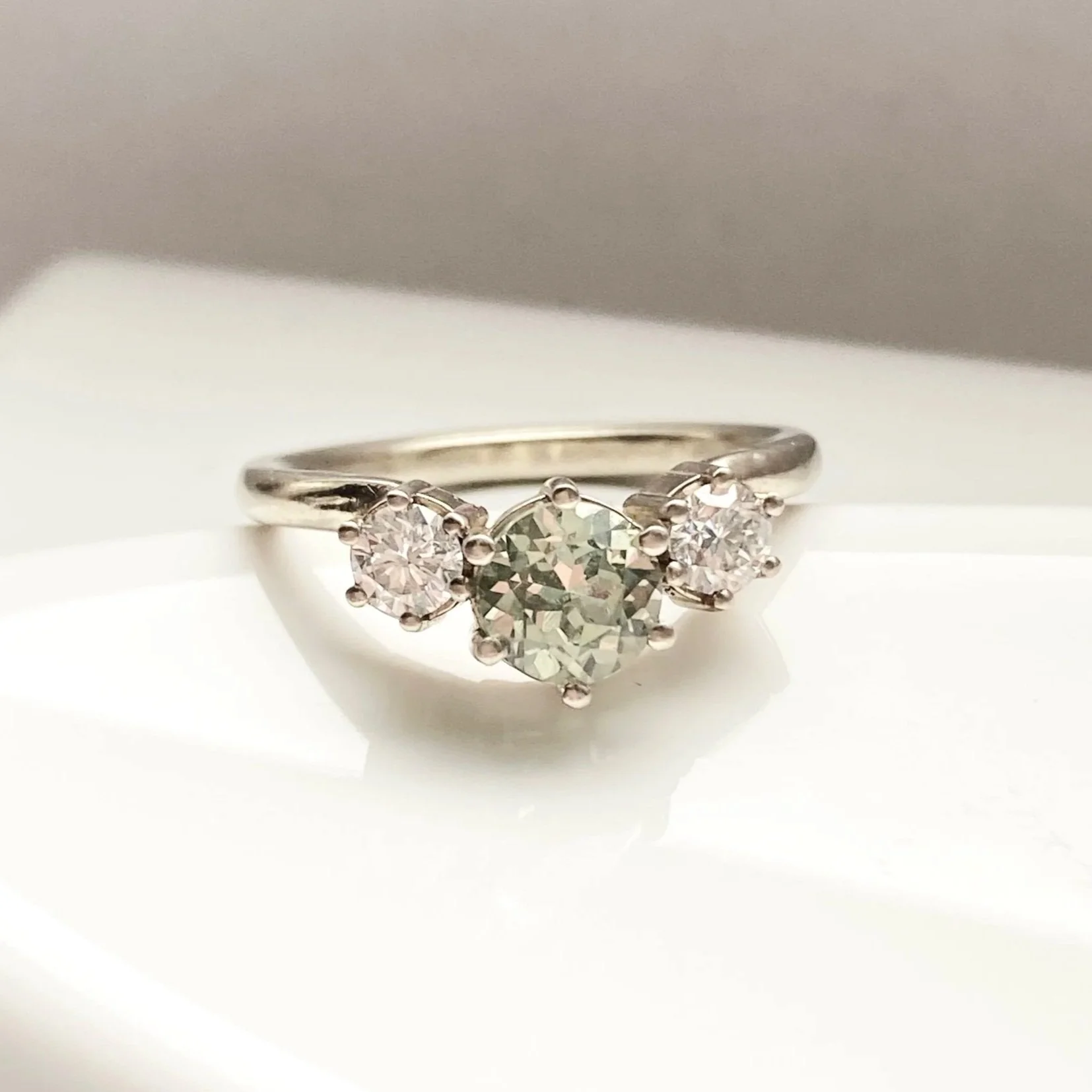 bette davis ring minty green lab grown sapphire with side ab diamonds flush edge engagement ring 14k recycled white gold on dish Kim Drosdick custom Jewellery
