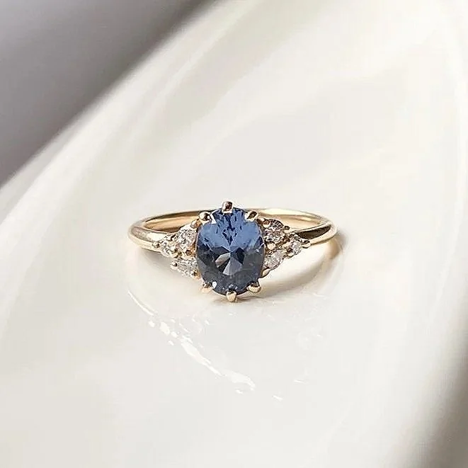 oval blue violet spinel diamond accents mirrored side clusters 14k yellow gold engagement ring Kim Drosdick Jewellery