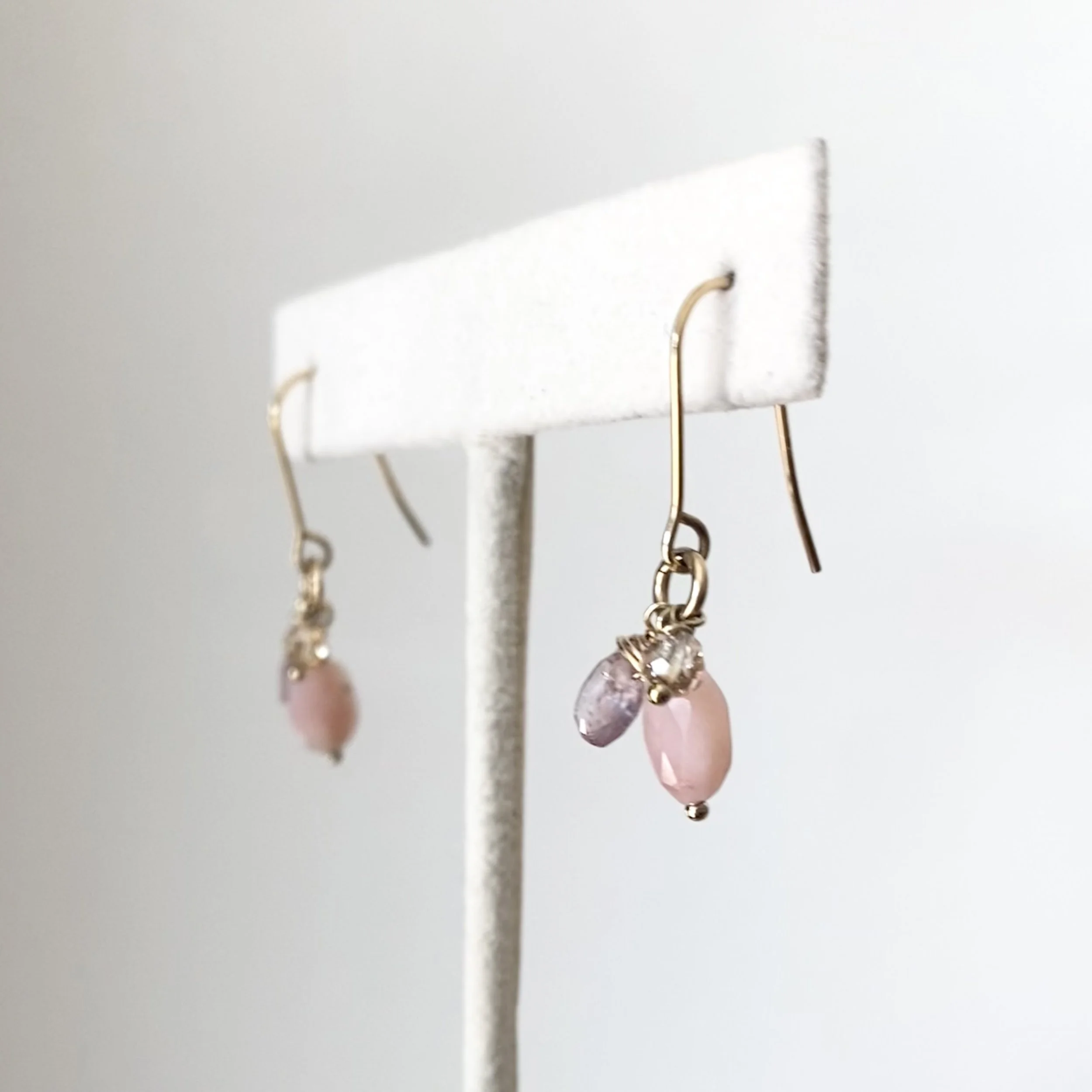 love charm dangly earrings by Kim Drosdick on earring stand in Toronto