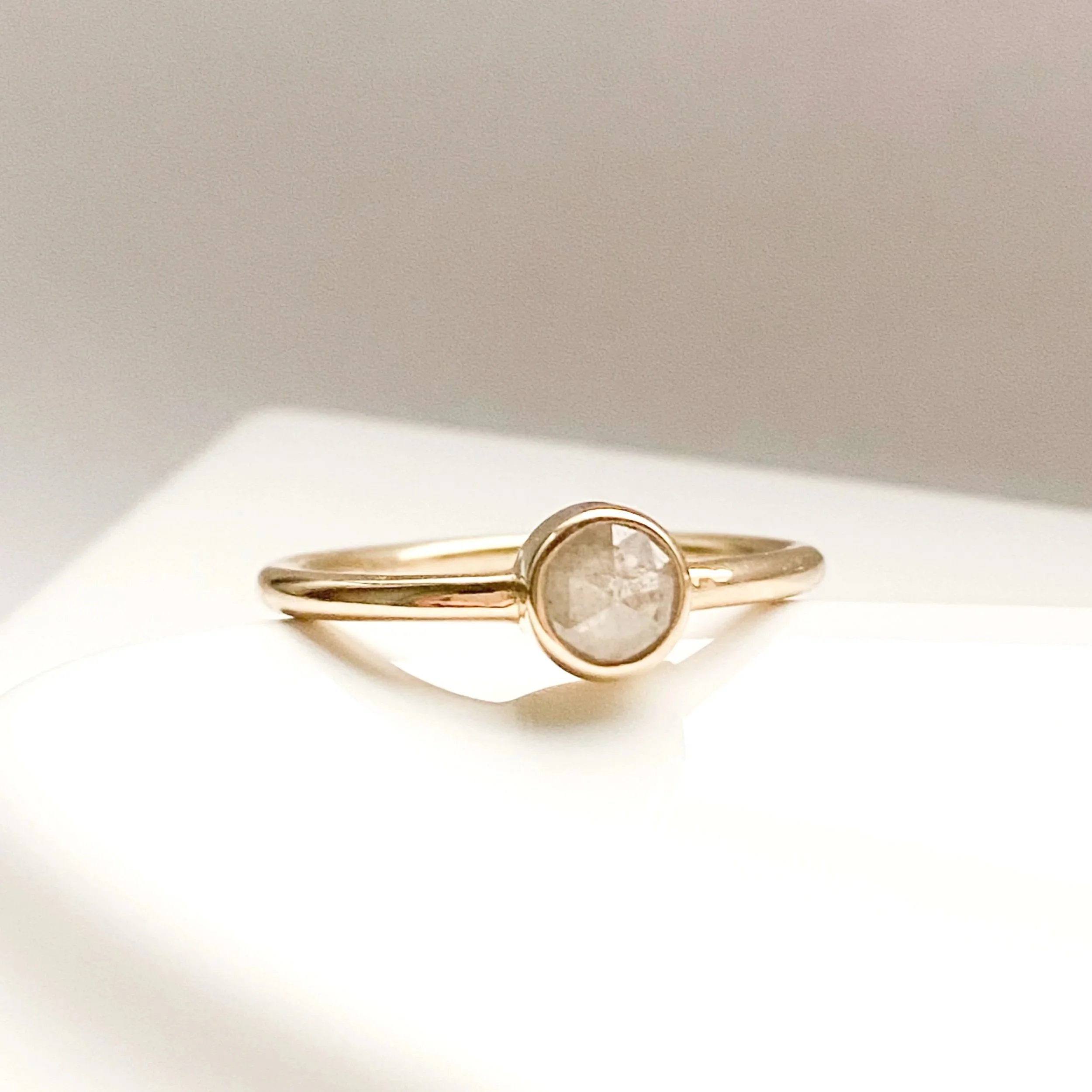 silvery salt pepper round rose cut diamond bezel set engagement stacking ring on dish Kim Drosdick Toronto