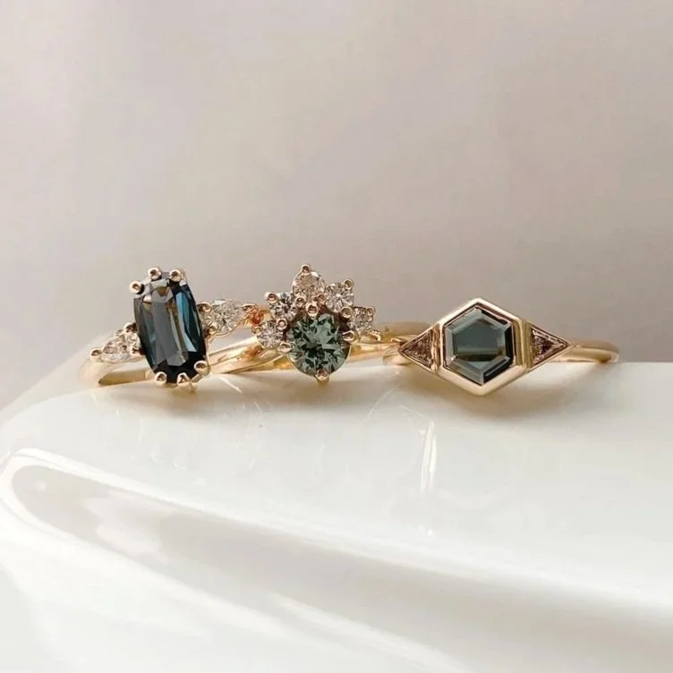 dark teak hexagonal spinel 3 stone engagement ring bezel settings rounded narrow band 14k yellow gold with other great engagement rings Kim Drosdick Jewellery Toronto