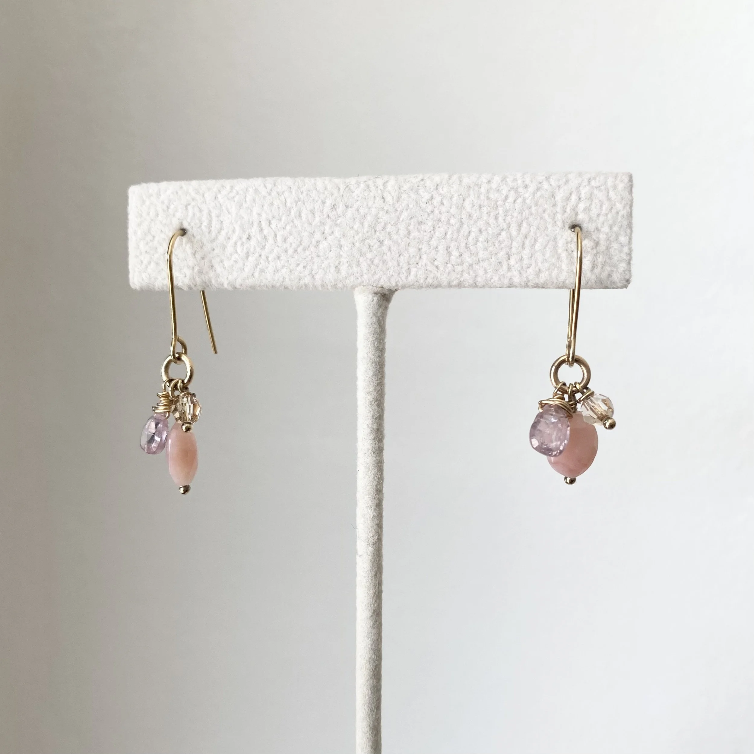 love charm dangly earrings rose quartz pink opal swarovski crystal gold filled wire  by Kim Drosdick on earring stand in Toronto