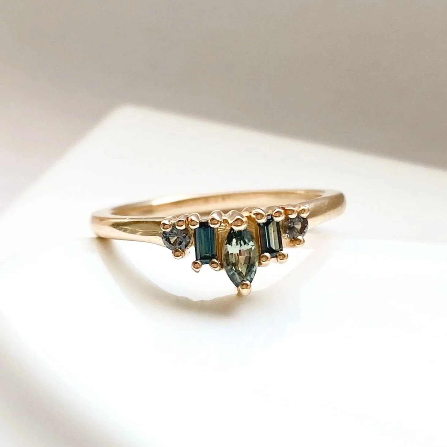 green sapphire mixed cut tiara recycled 14k yellow gold engagement wedding ring reverse angle on white dish kim drosdick toronto