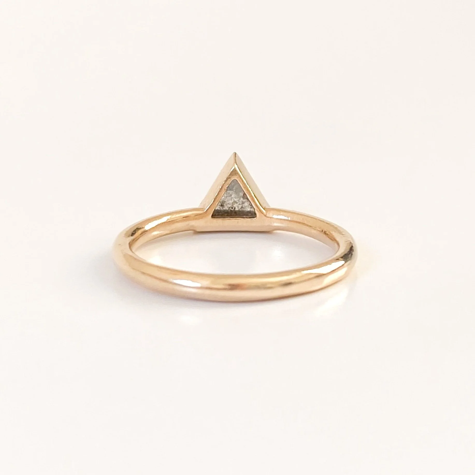 darker triangle salt and pepper diamond bezel set off side bottom justified to round wire band 14k yellow gold underside of bezel view Kim Drosdick Jewellery Toronto