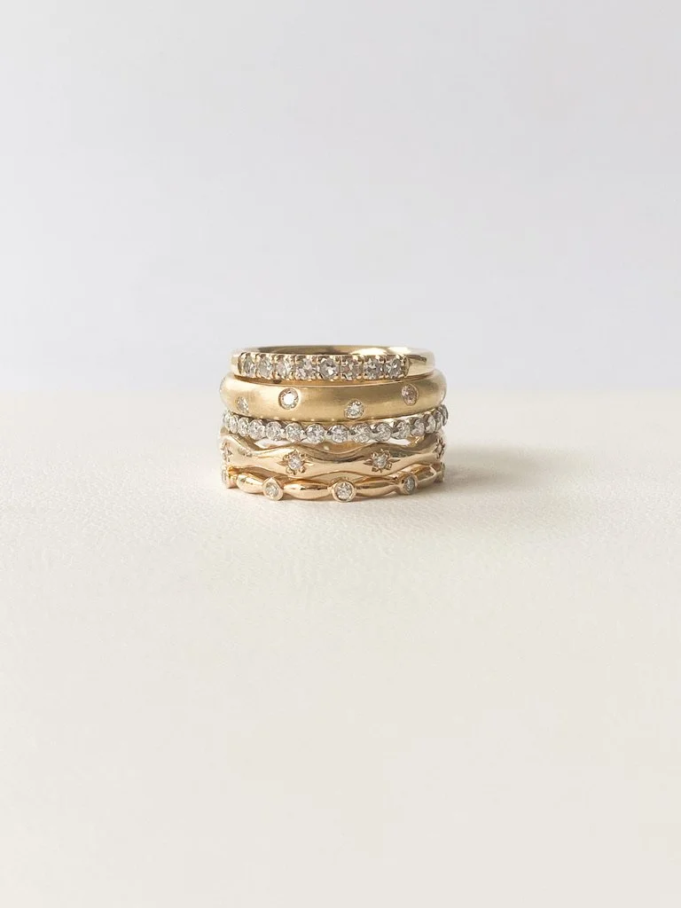 lab diamond and platinum eternity wedding stacking ring shared single claw on prop in stack