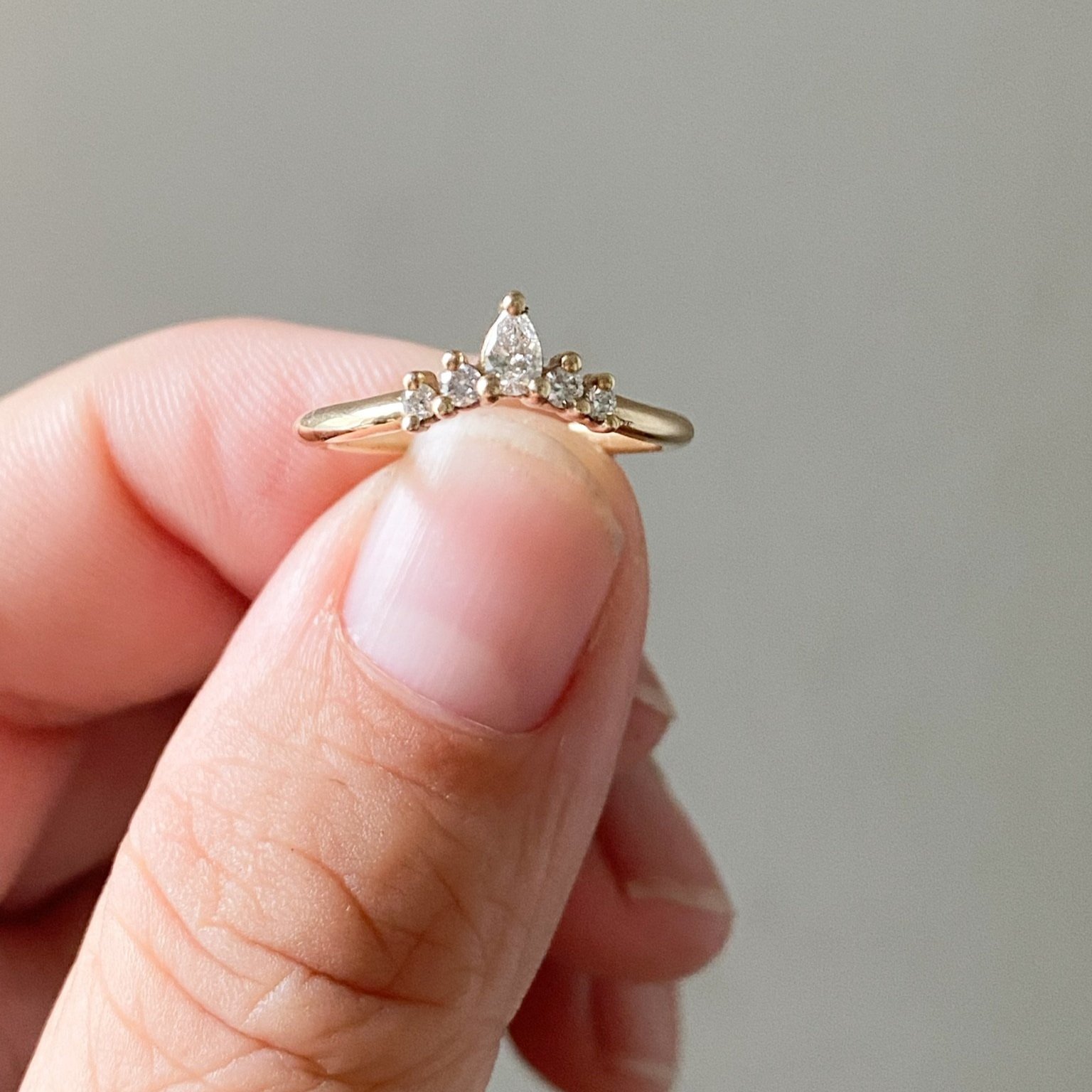 5 stone earth mined diamond tiara wedding ring pear and round shapes 14k recycled yellow gold in finger tips kim drosdick toronto