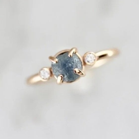 round Montana blue green claw set engagement ring with side bezel set champagne diamonds 14k yellow gold front view Kim Drosdick Jewellery Toronto