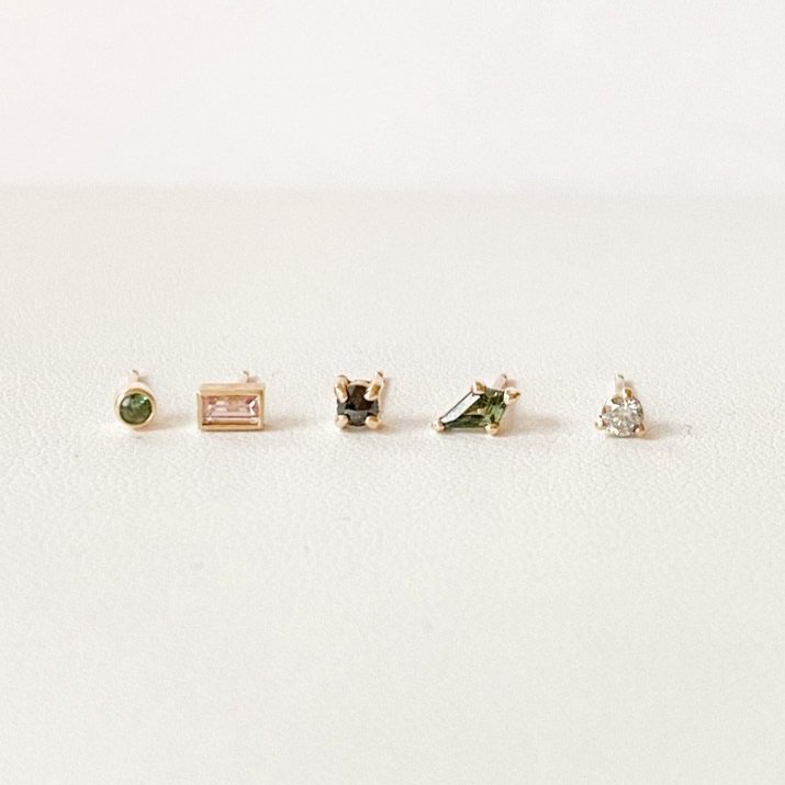 green sapphire kite shape sapphire studs claw set geometric earrings 14k yellow gold Kim Drosdick Toronto pictured with other stud earrings
