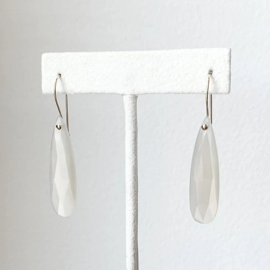 long faceted teardrop moonstone drop earrings with gold filled findings made by Kim Drosdick shown on earring stand