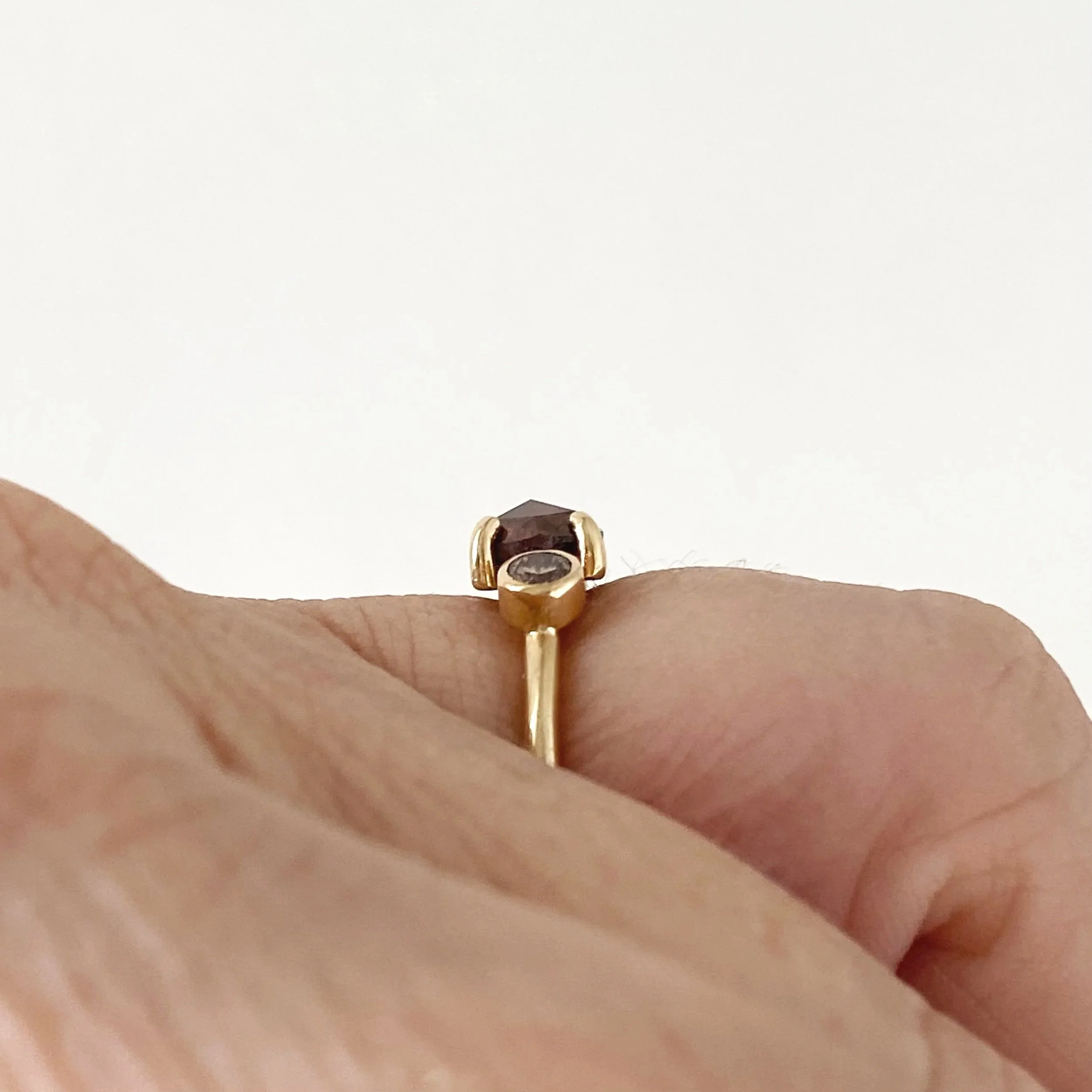 round deep red rose cut claw set diamond flanked by bezel set champagne brilliant cut diamonds 14k yellow gold side view Kim Drosdick Jewellery Toronto