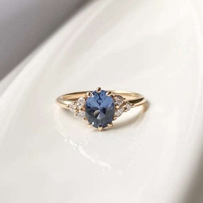oval blue violet spinel diamond accents mirrored side clusters 14k yellow gold engagement ring alt angle Kim Drosdick Jewellery