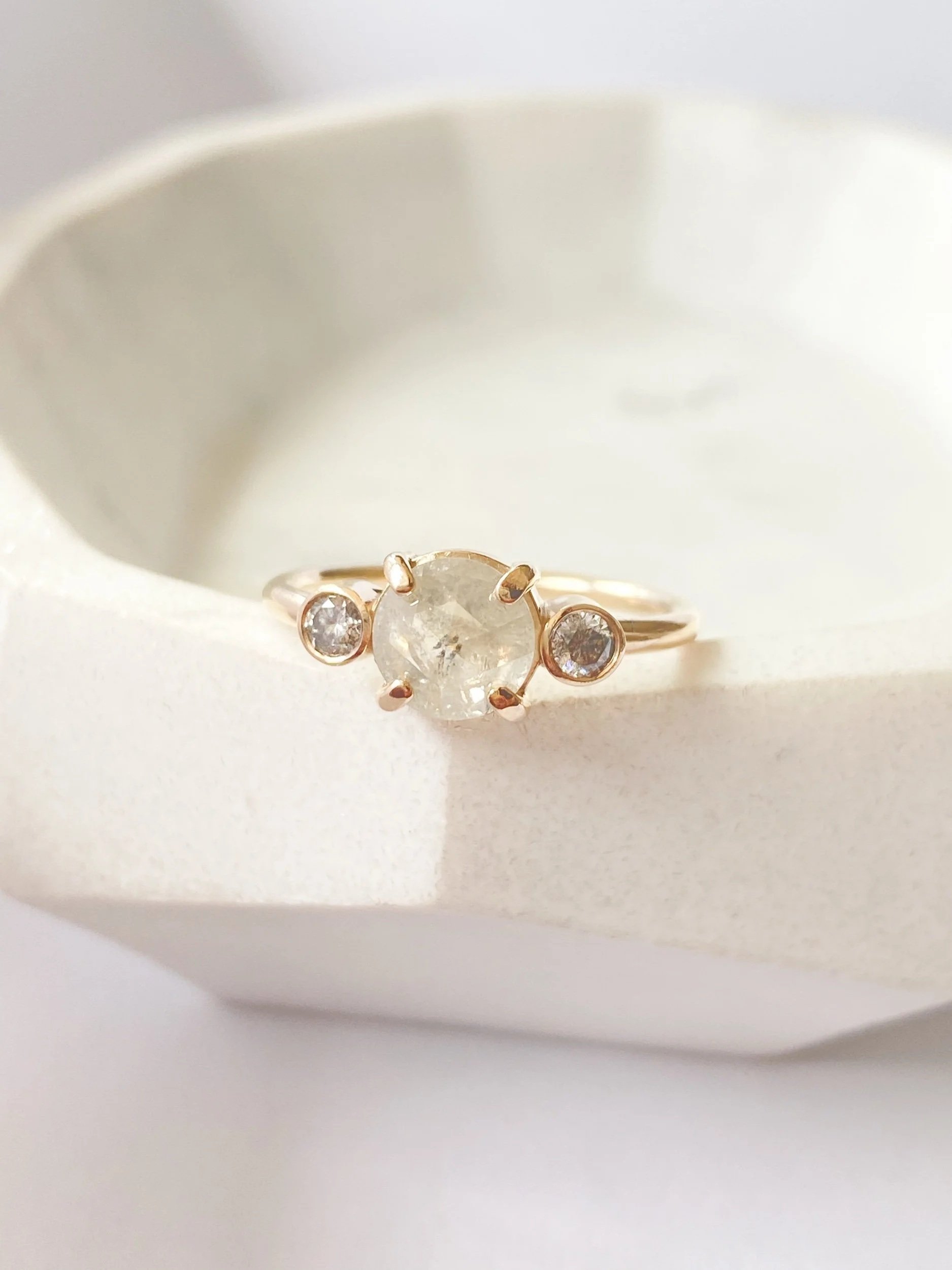 tone engagement ring with bezel set sides 14k yellow gold front view on a prop dish Kim Drosdick Jewellery Toronto